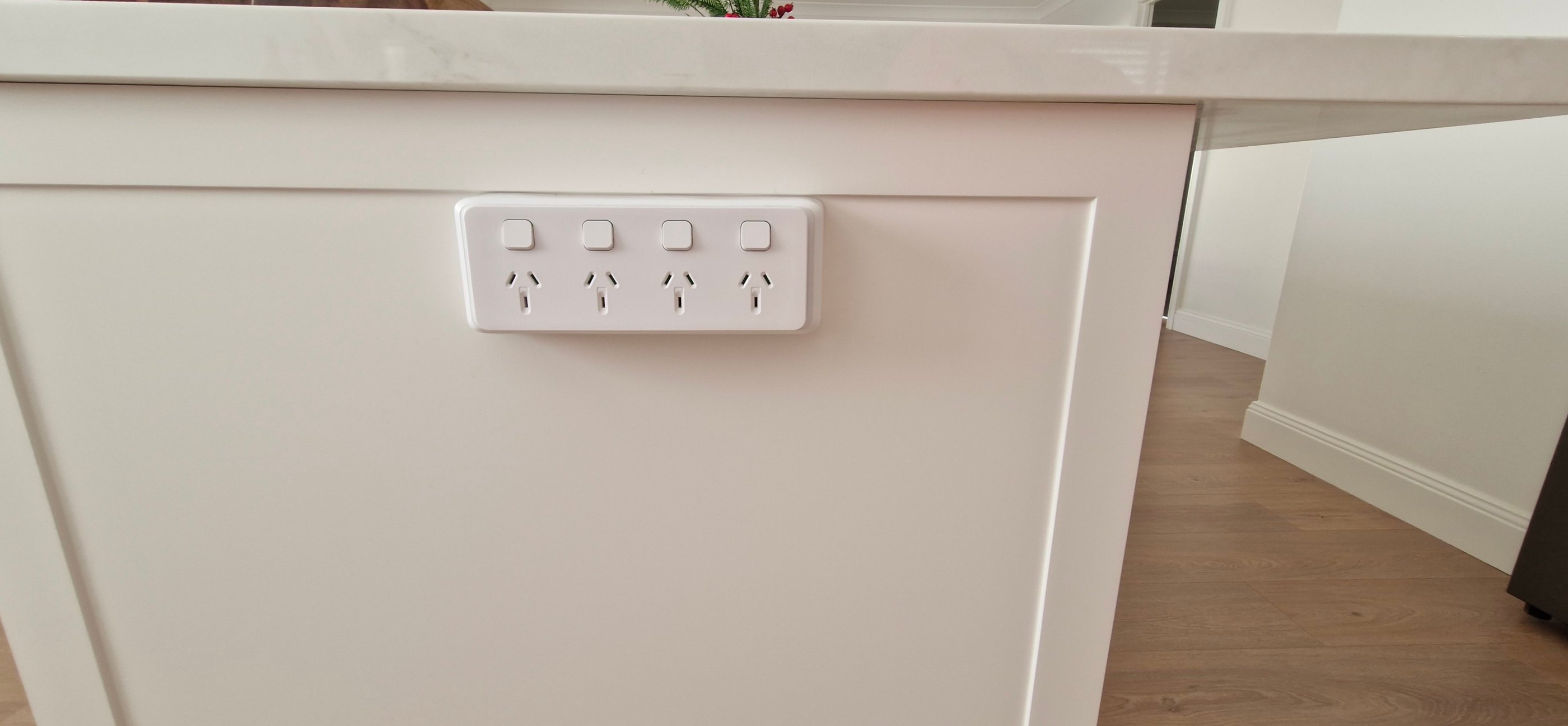 a white quad power point on the side of an island bench