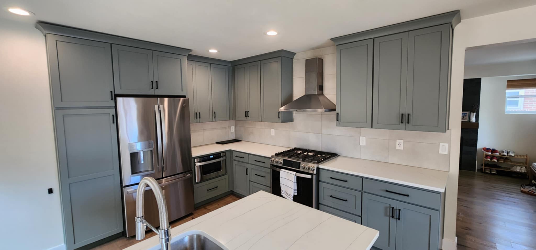 a kitchen with a stove top oven and a refrigerator
