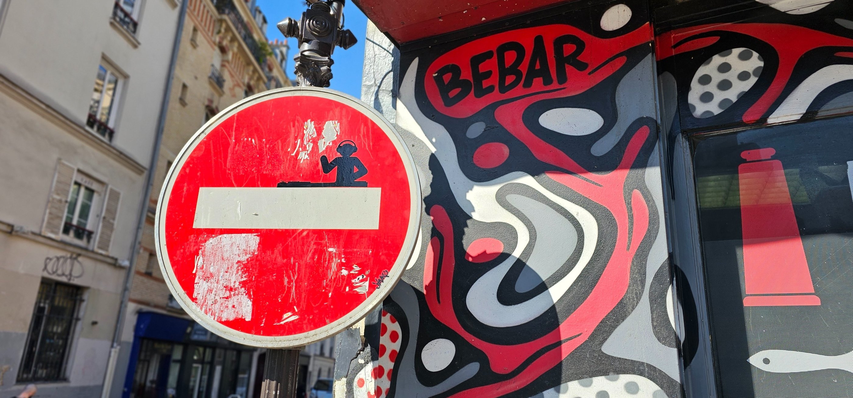 a red and white sign with a no entry sign