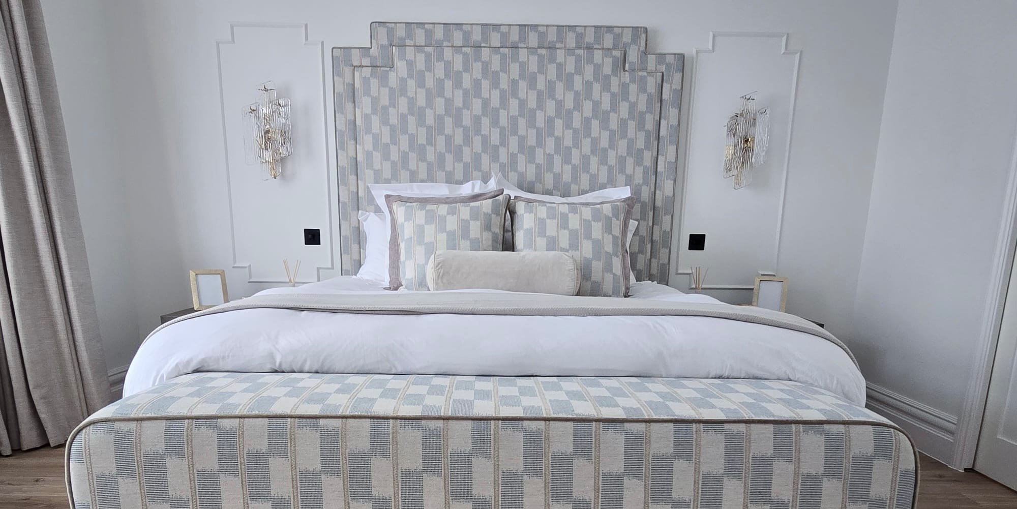 Elegant master bedroom with a modern bed, stylish decor, and ambient lighting