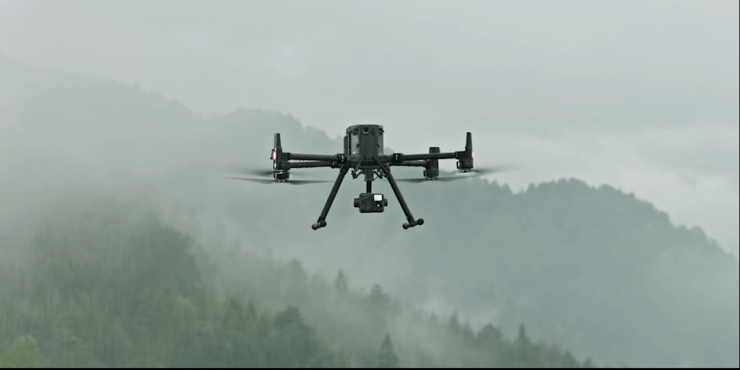 a small drone flying over a mountain range