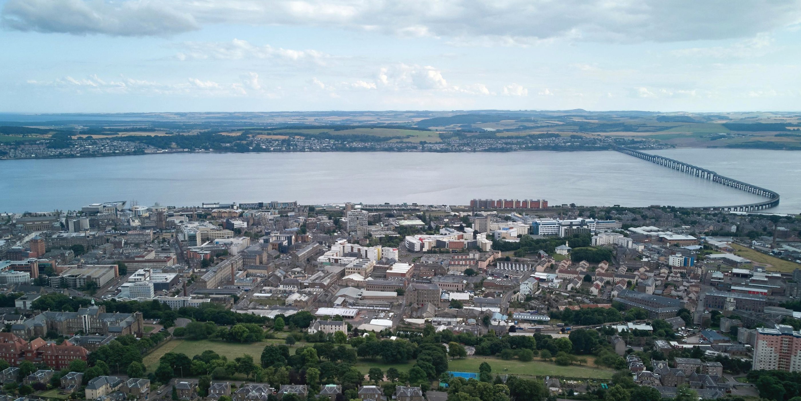 Aerial view of Dundee city skyline and Tay Road Bridge spanning the River Tay in Scotland.