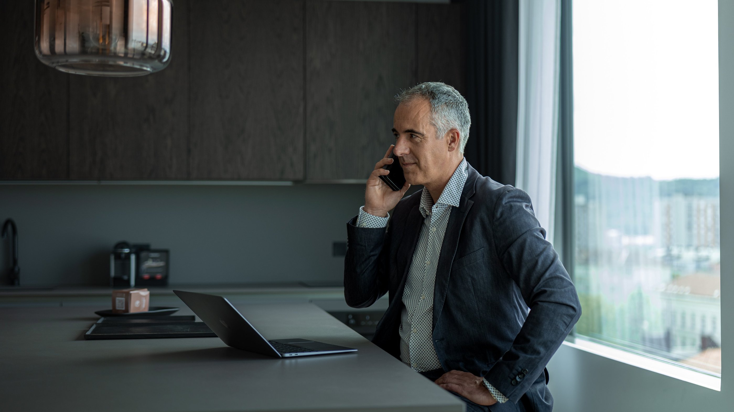 a man in a suit and tie is talking on the phone