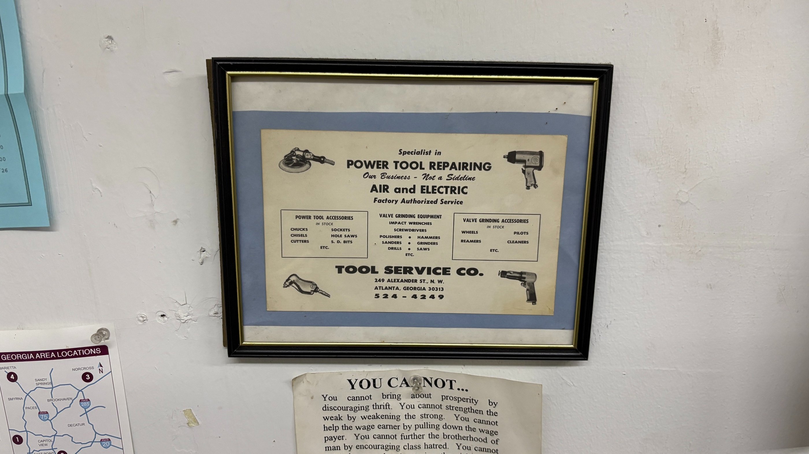 Vintage framed advertisement for a power tool repair shop specializing in air and electric tool service.