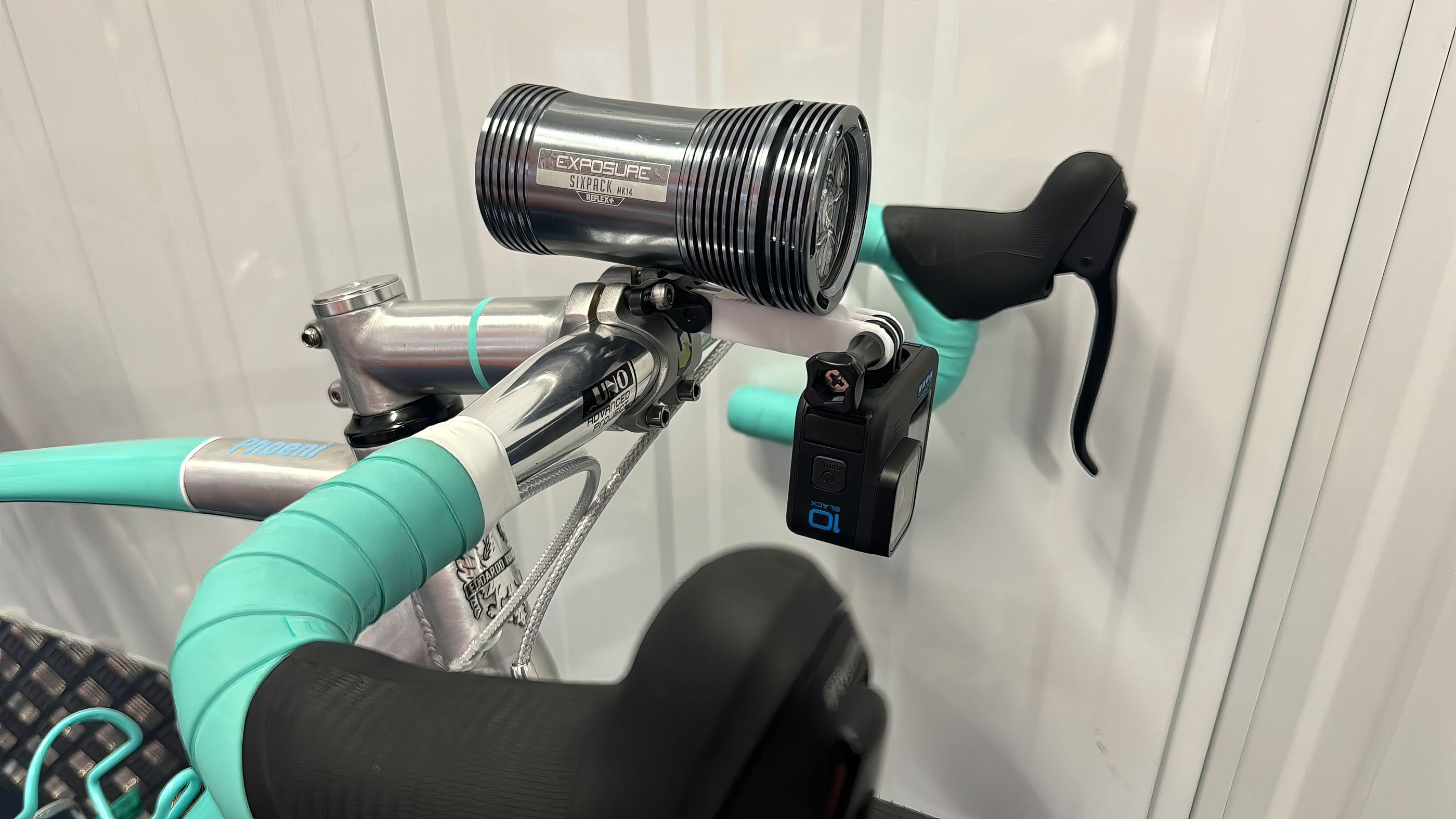 combo mount on a green bike with exposure light and Gopro camera installed
