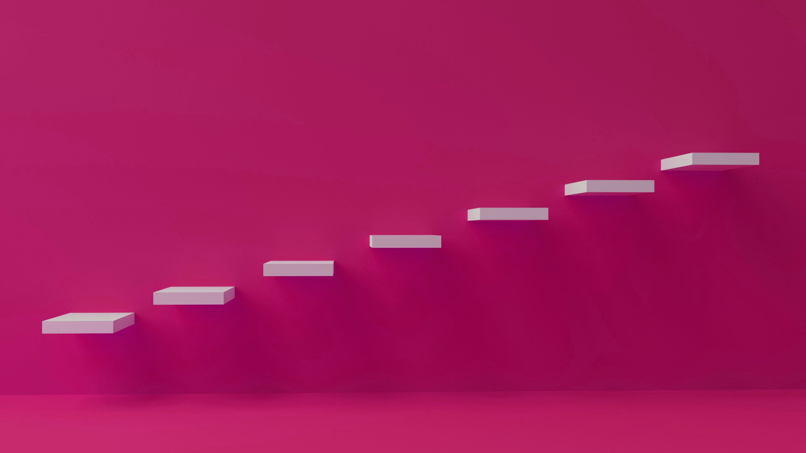 A set of stairs set into the wall against a brightly painted pink wall