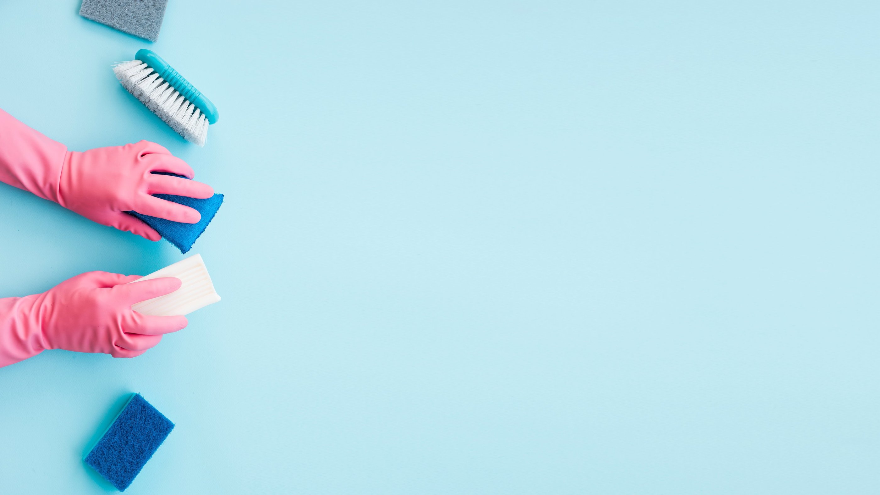 a person in gloves and gloves cleaning a blue surface