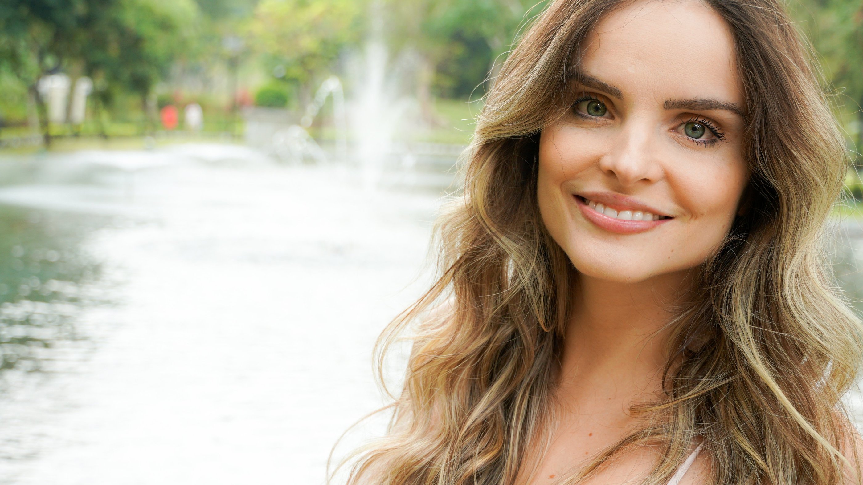 a woman with long hair and a white top