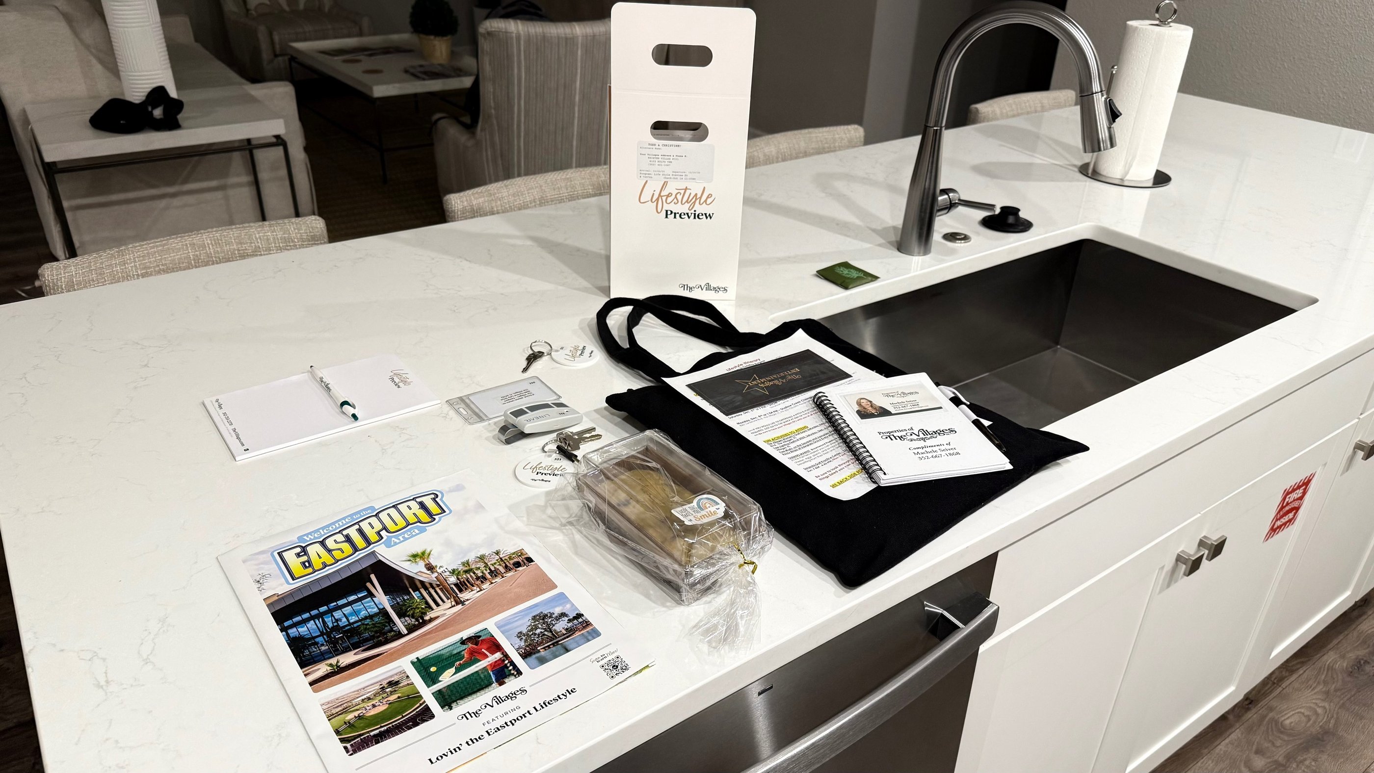 Lifestyle Preview welcome materials, keys, and maps displayed on the kitchen island at The Villages