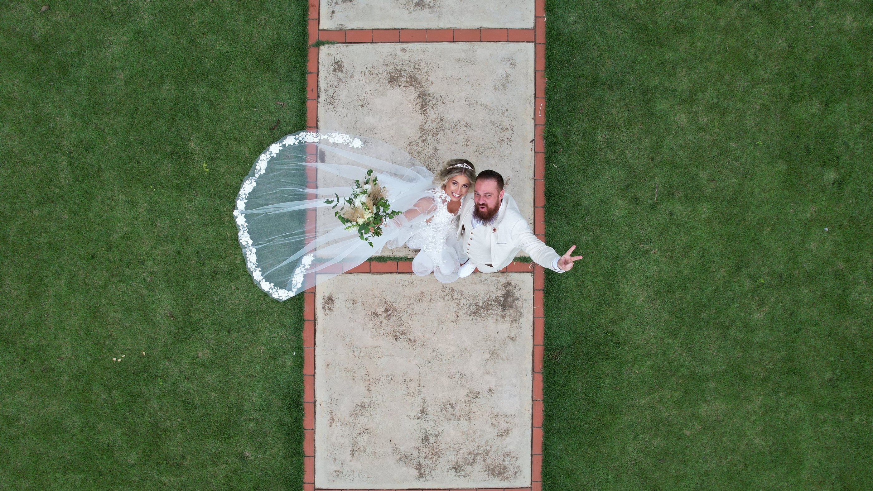 a bride and groom standing on a path