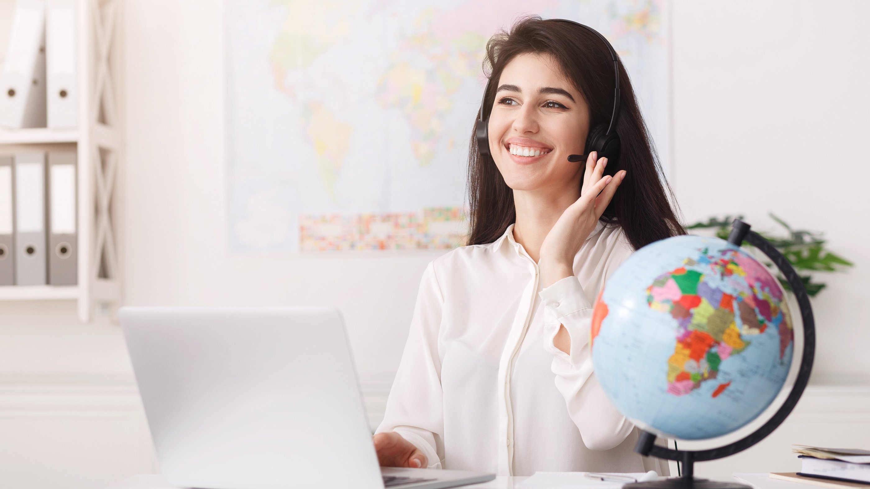 a woman in a white shirt and a globe providing customer services