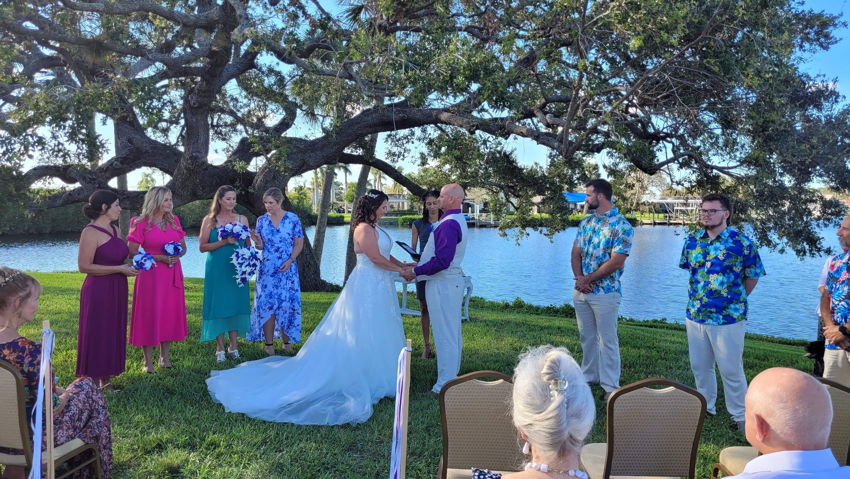 a wedding ceremony in a park with a bride and groom