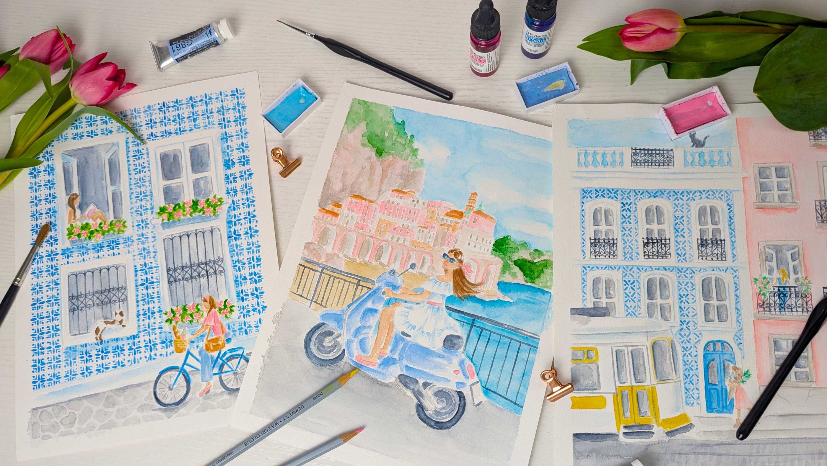 Flat lay with Watercolor Art featuring Italy and Portugal inspired art prints.