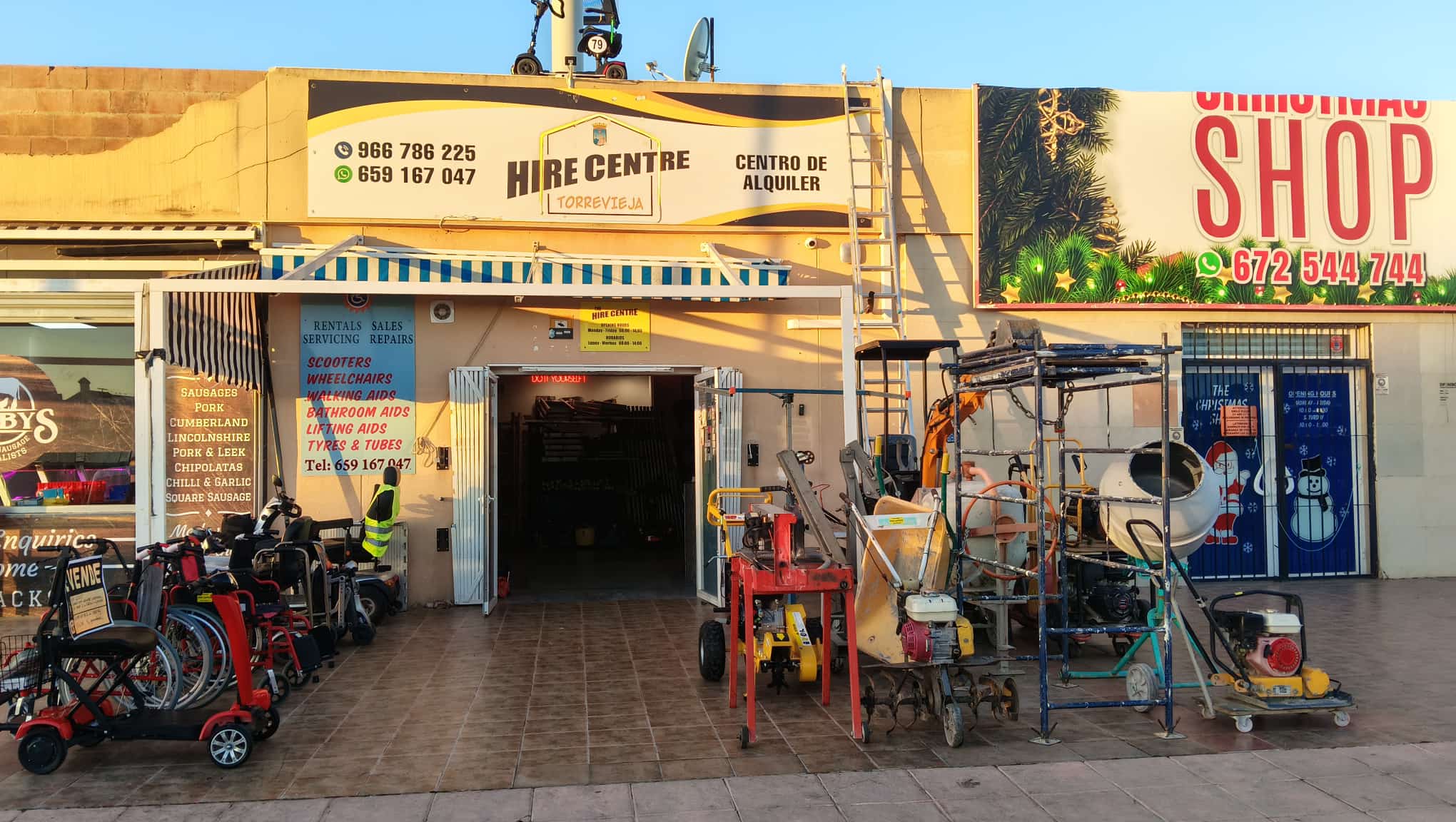 Hire Centre Torrevieja storefront featuring mobility scooters and construction equipment rentals.