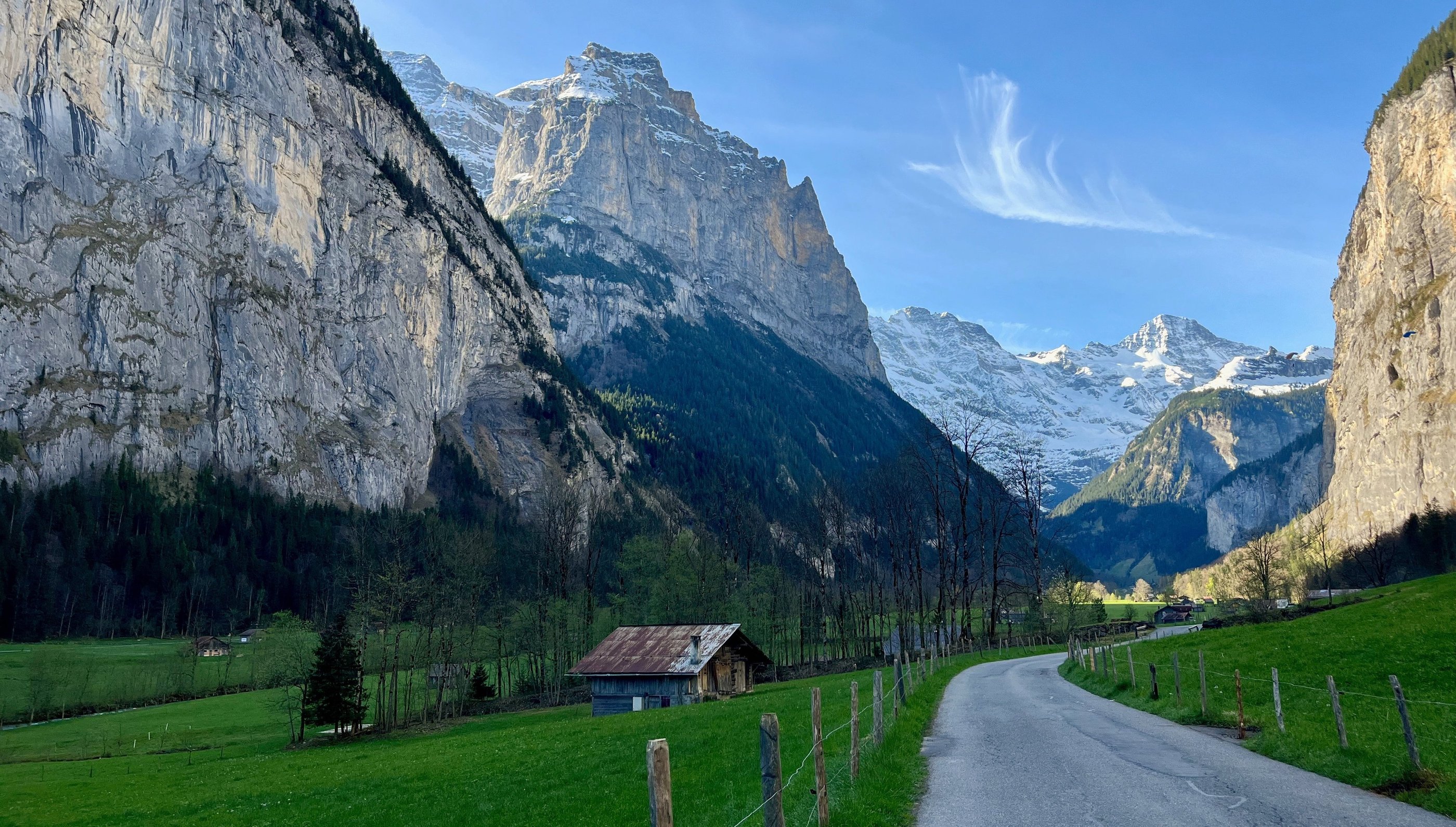 View looking up the Lauterbrunnen Valley in Switzerland with limestone cliffs towering above