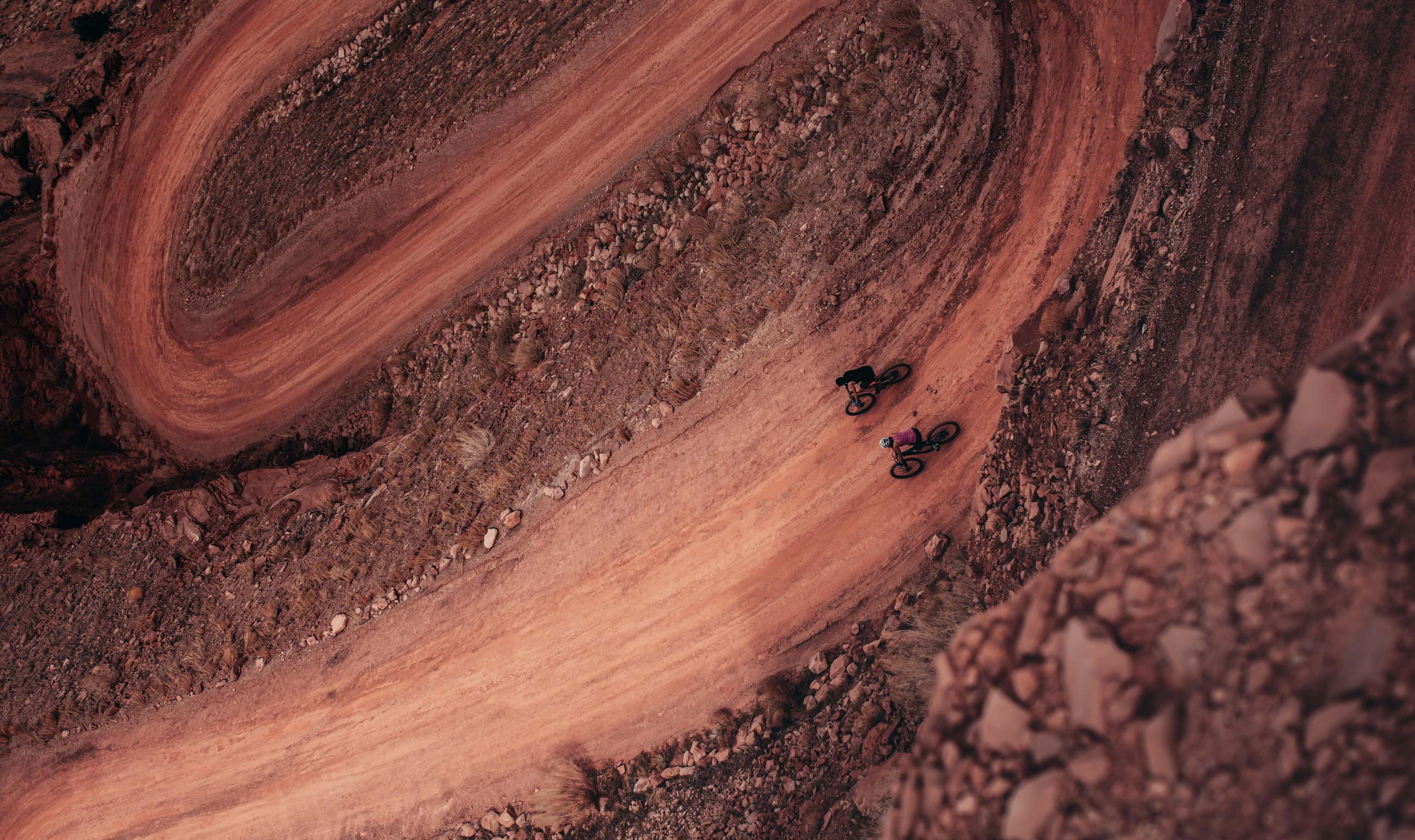 a person riding a bike on a dirt road