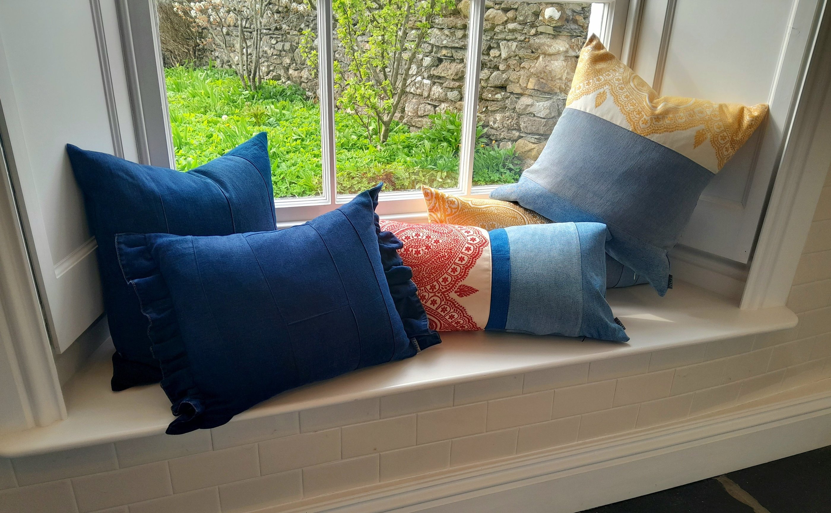 Repurposed vintage cushions on a classic Victorian window seat.