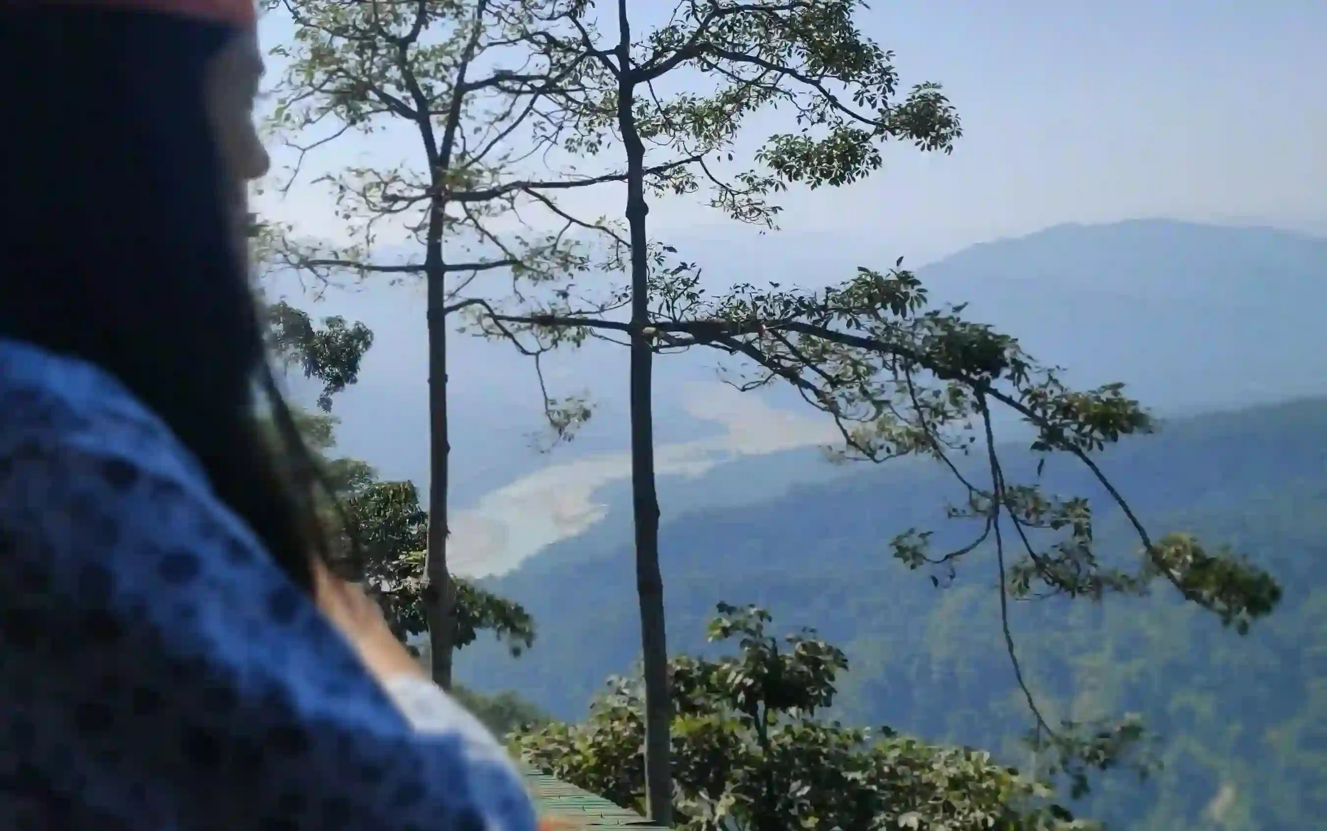 A woman looking at the mountains.