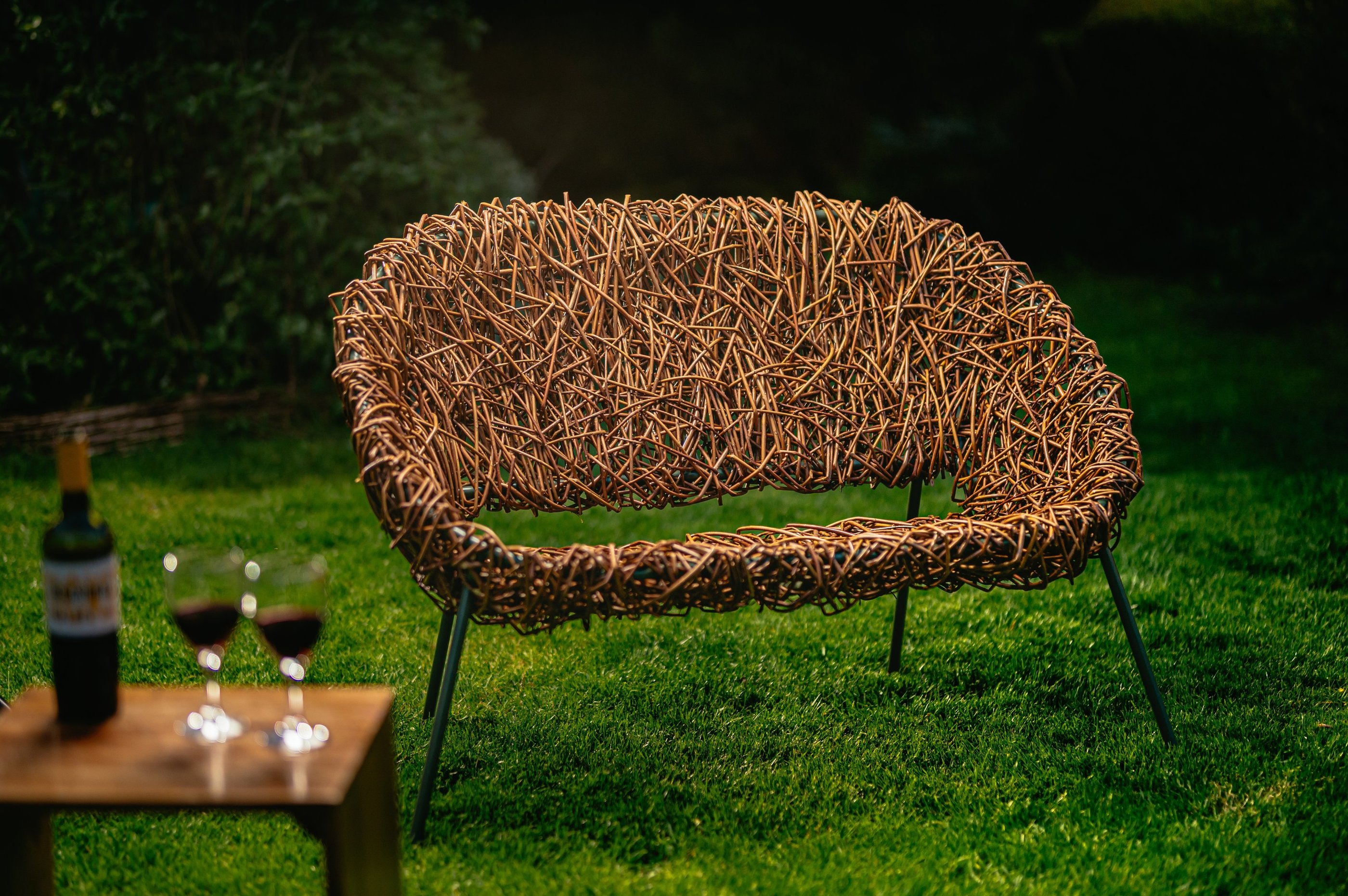 Bespoke 2-seater willow chair with modern green metal frame, handwoven design