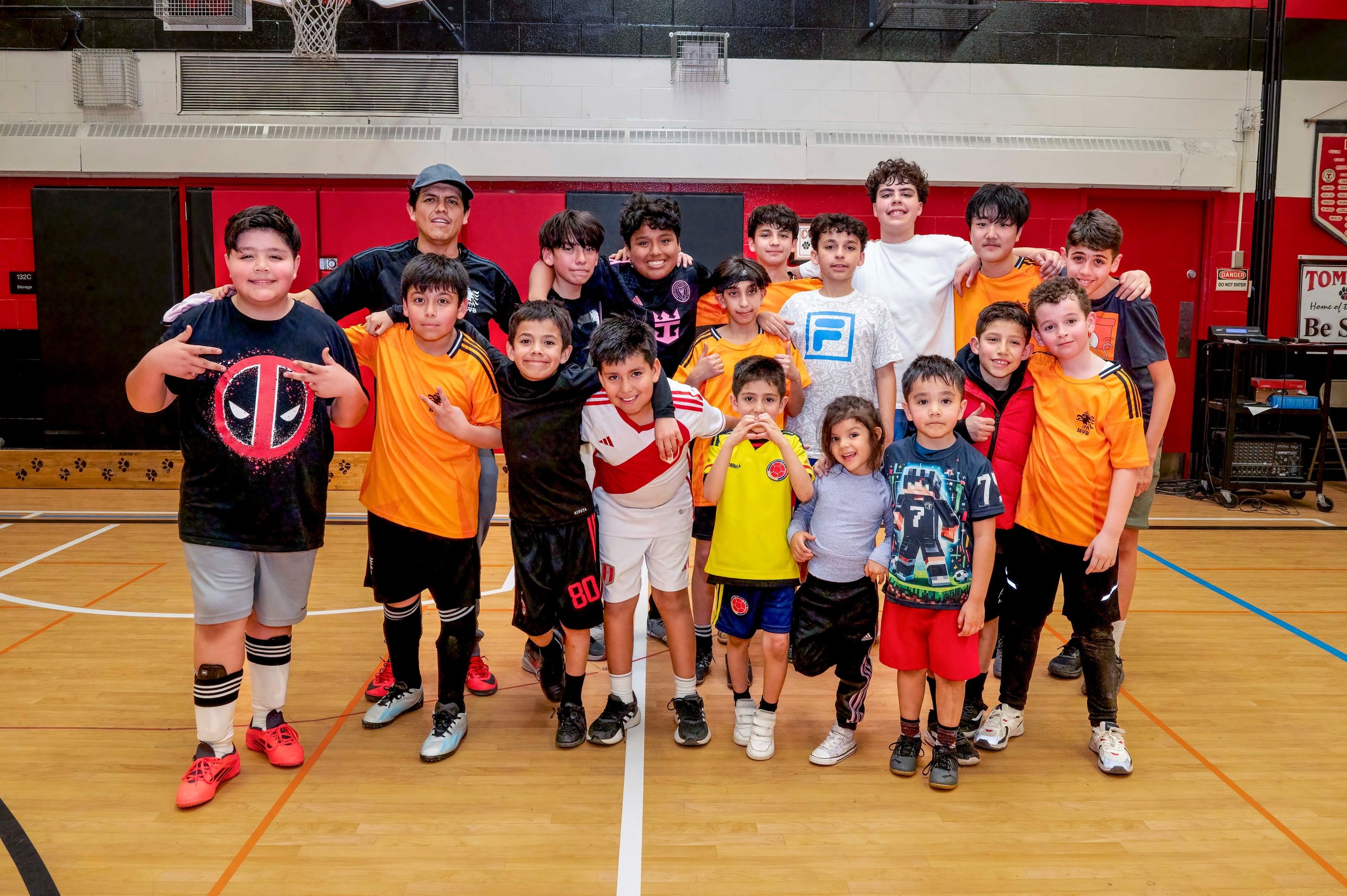 A diverse youth indoor soccer students MVB FC posing for a group photo in Mississauga
