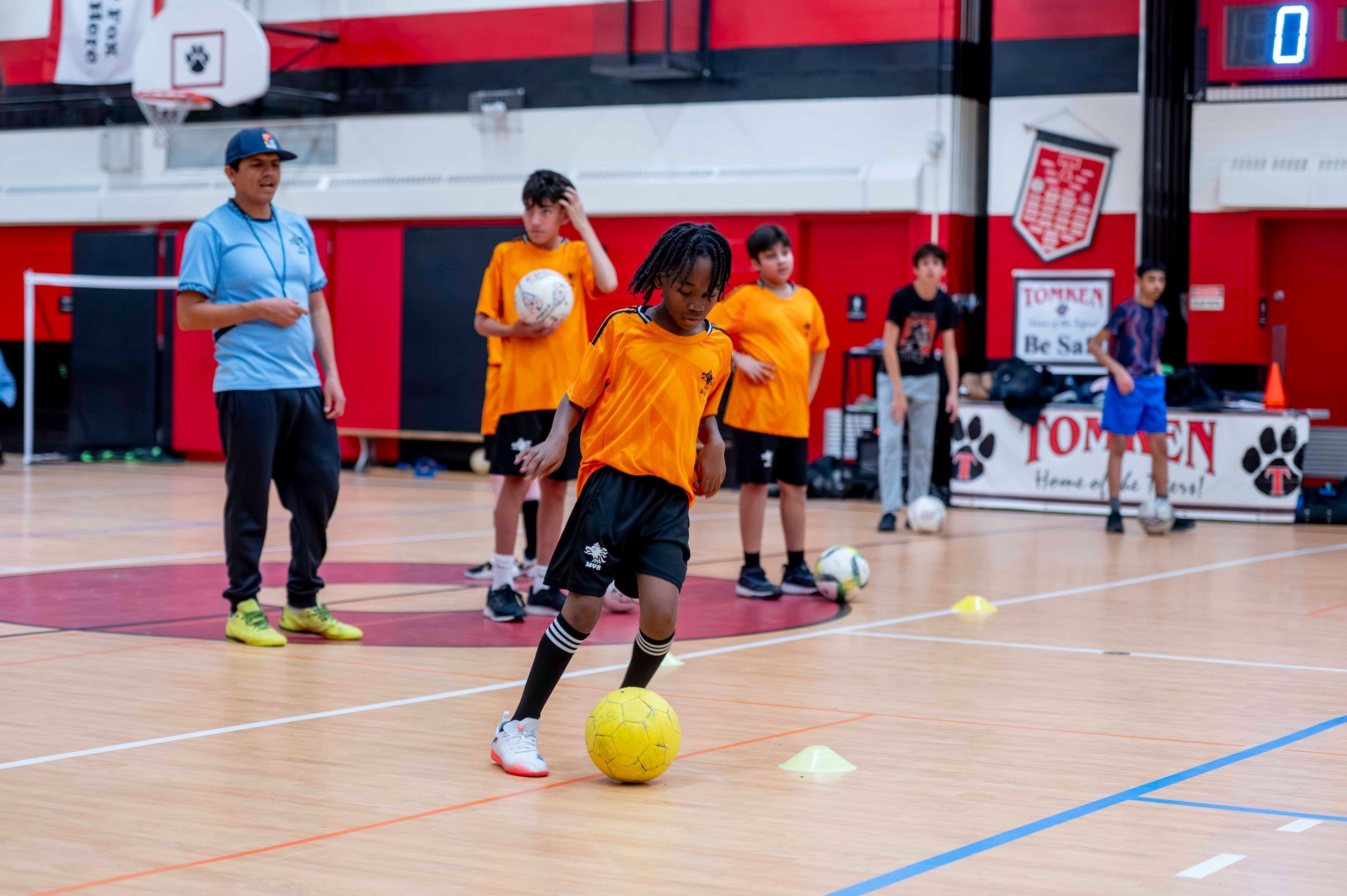 MBV FC Soccer player practices soccer ball dribbling drills at an indoor soccer class.