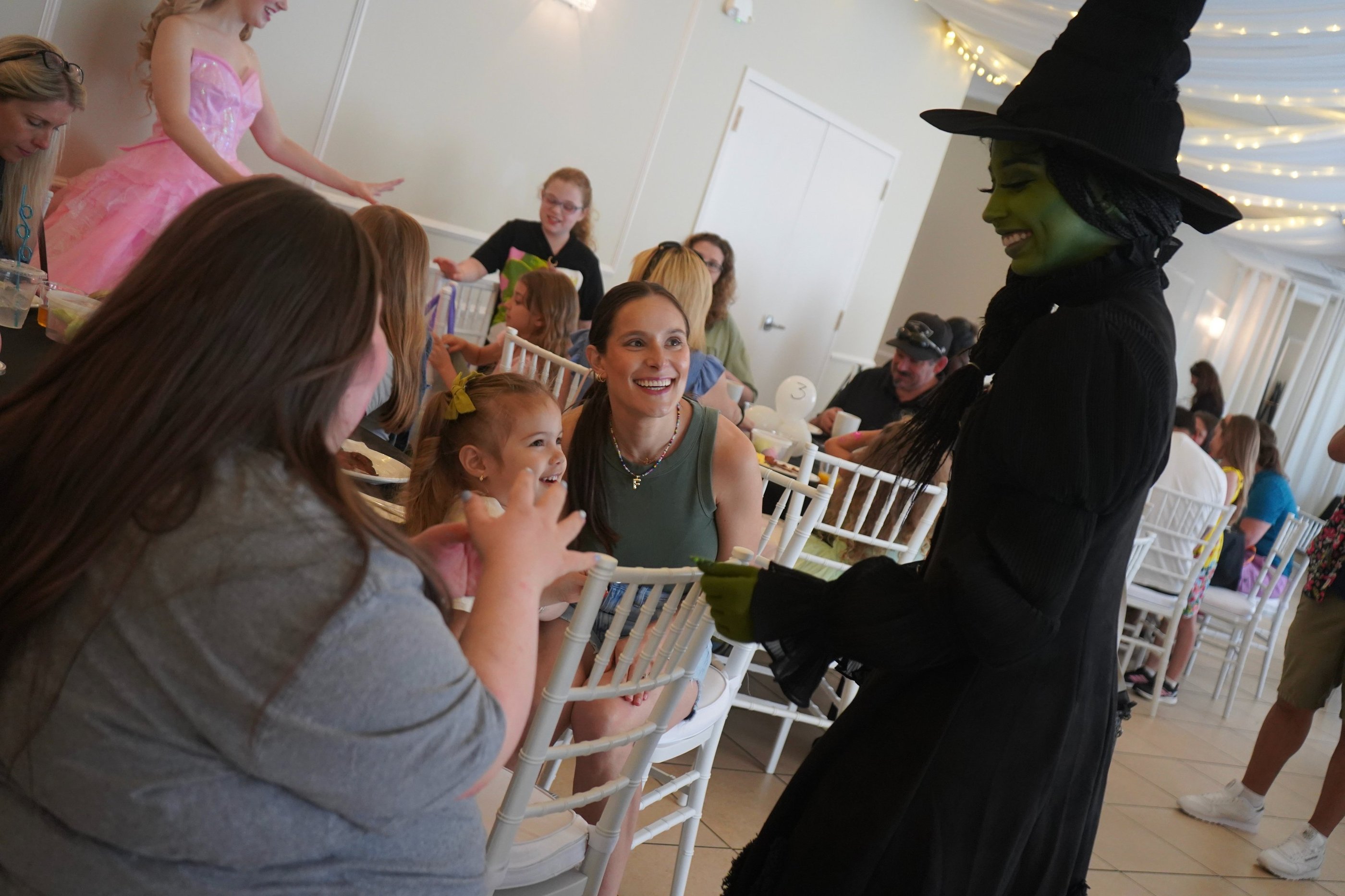 Elphaba talking with guests during a dining experience