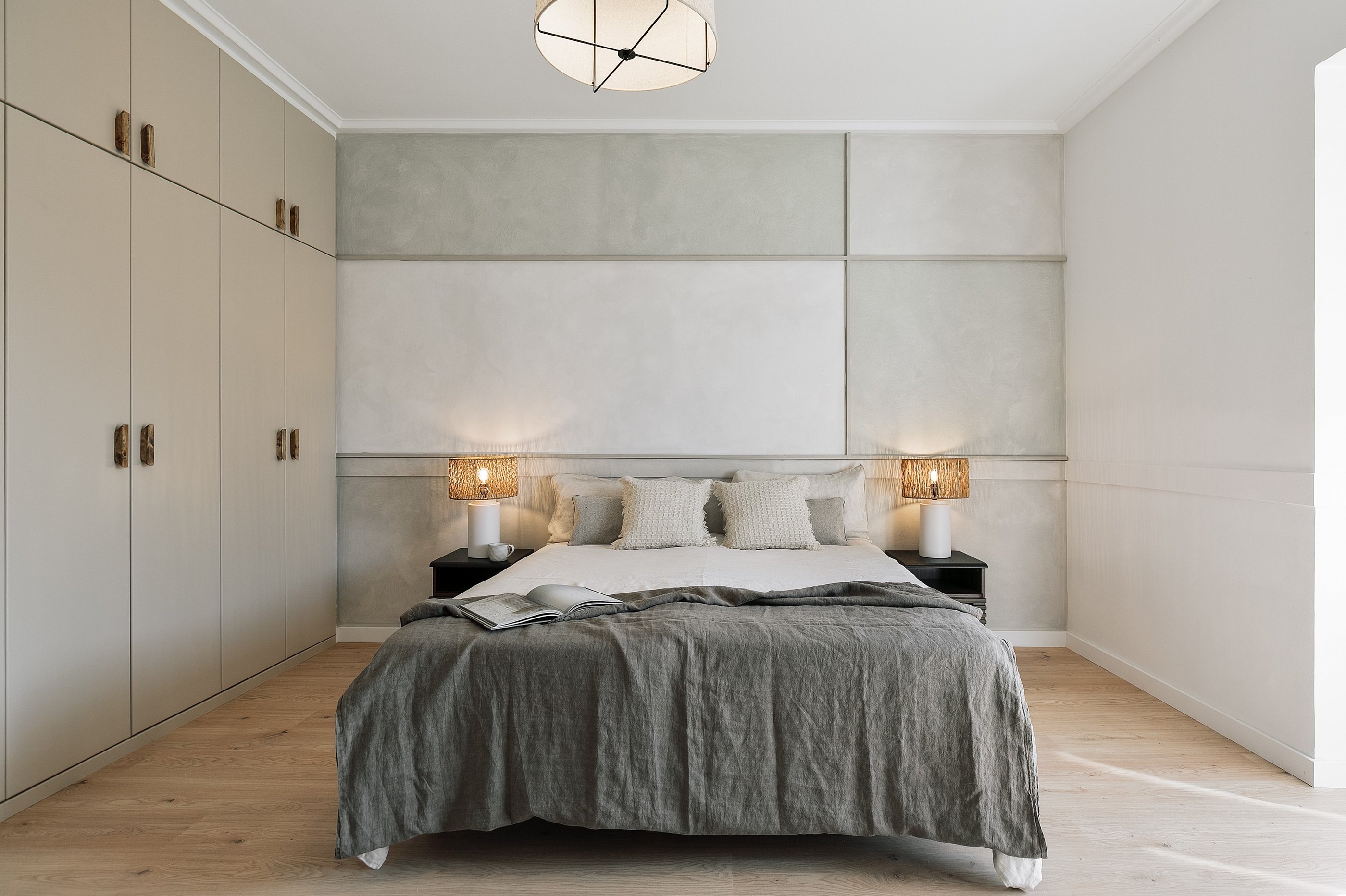 Elegant bedroom with subtle wall art, and calm beige tones, designed by SAVIA in Barcelona