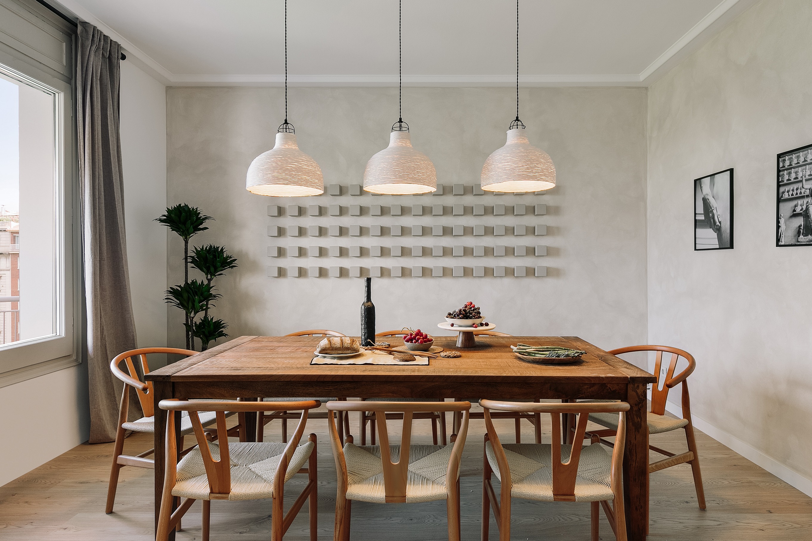 Dining area with elegant decor, wooden table and chairs, custom lighting and calming design by SAVIA