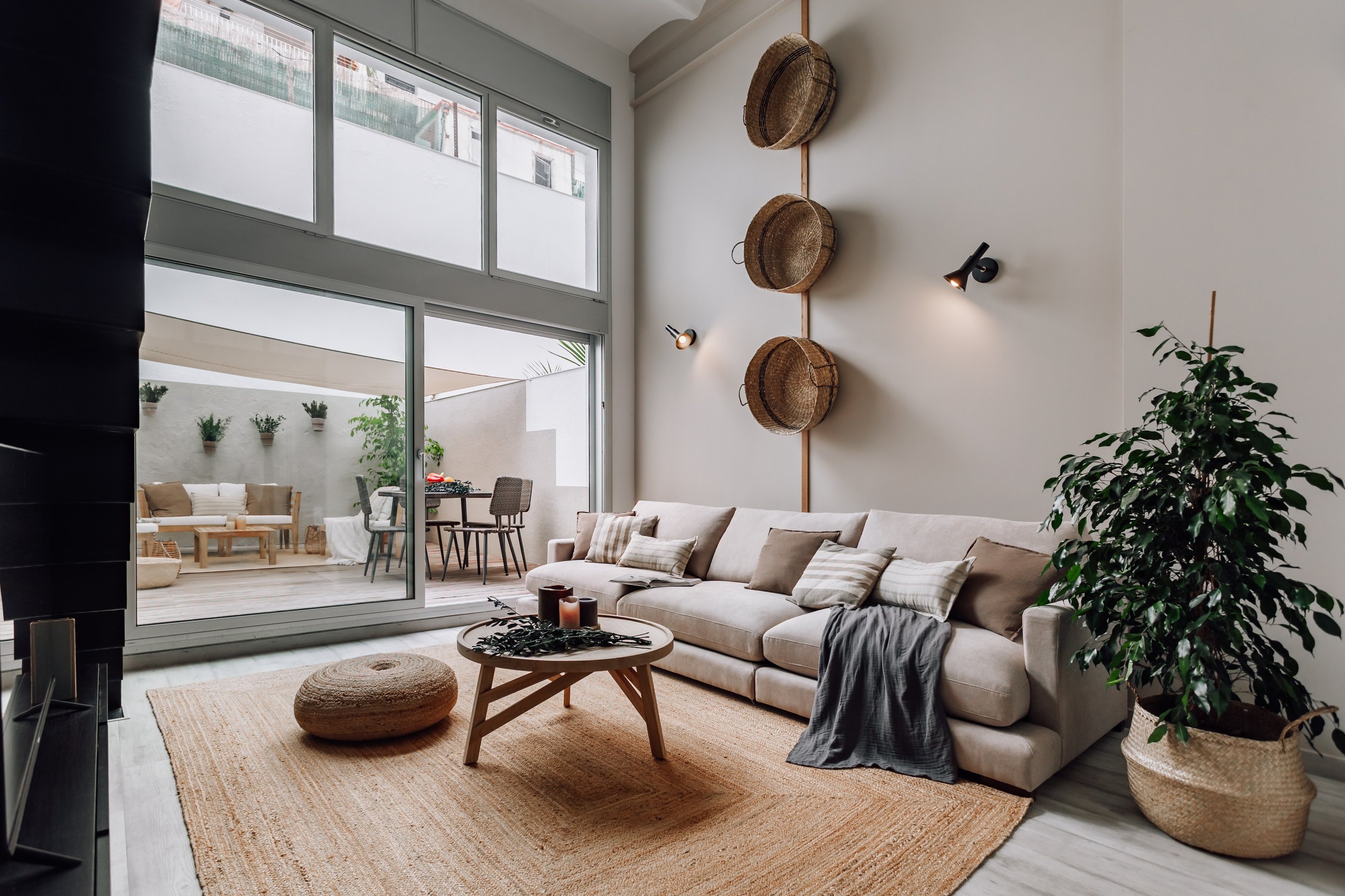 Cozy outdoor terrace with seating and sofa and natural textures in Barcelona residential design