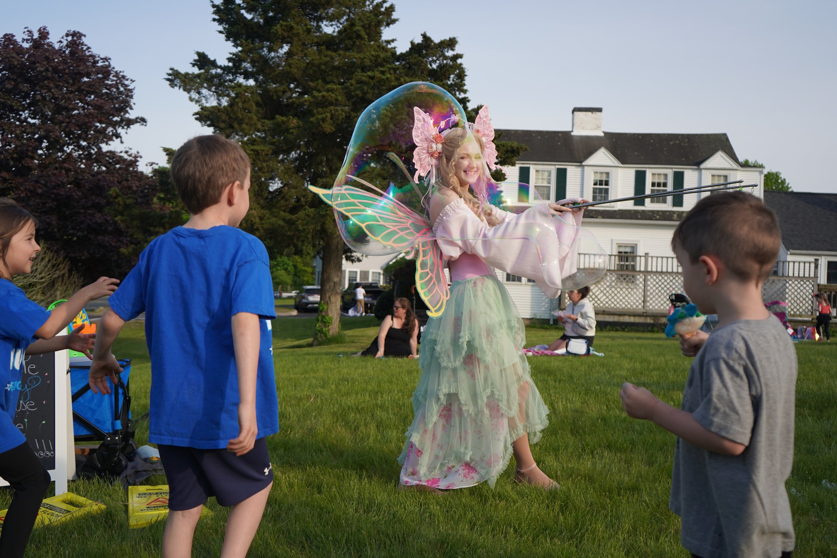 Bubble fairy making bubbles for guests