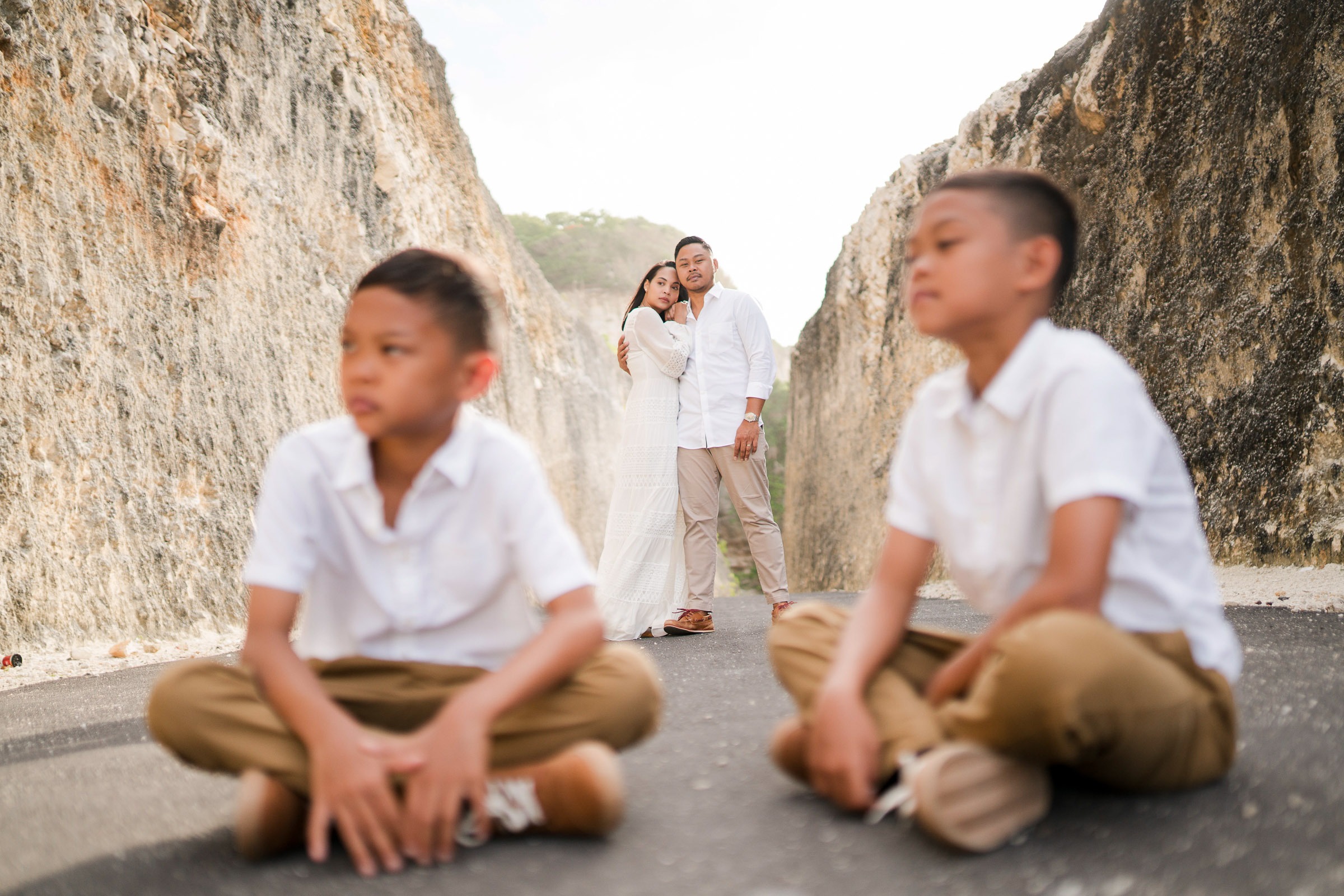 Portrait of Ayunda brothers sitting together during a family photography session at Melasti Beach Bali.