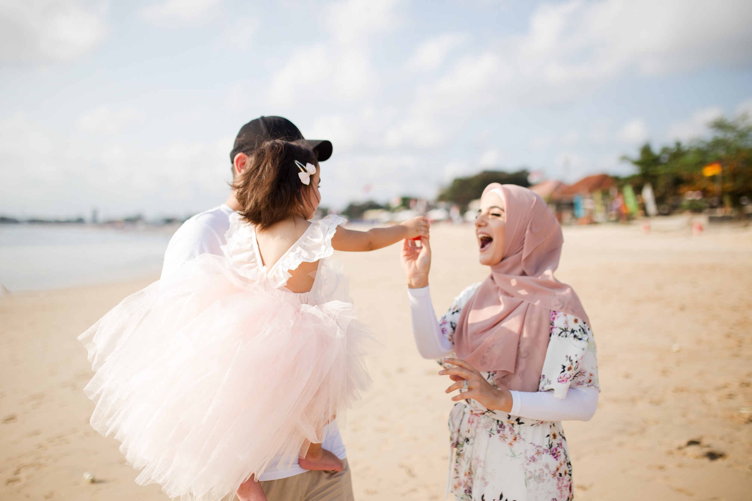 family session Jimbaran Beach Bali mother and child walking together by the sea