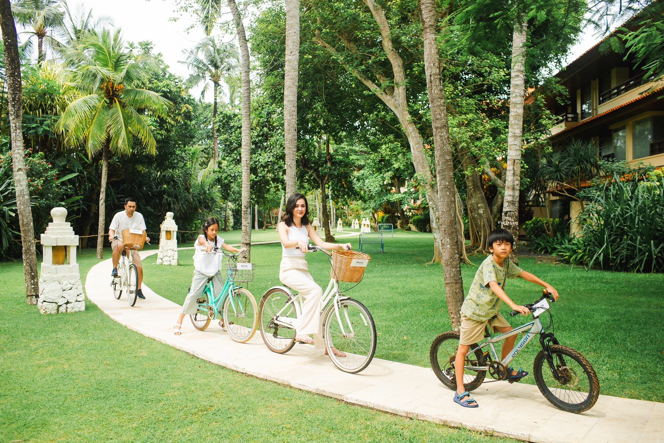 family cycling together during Westin Nusa Dua Bali photography session
