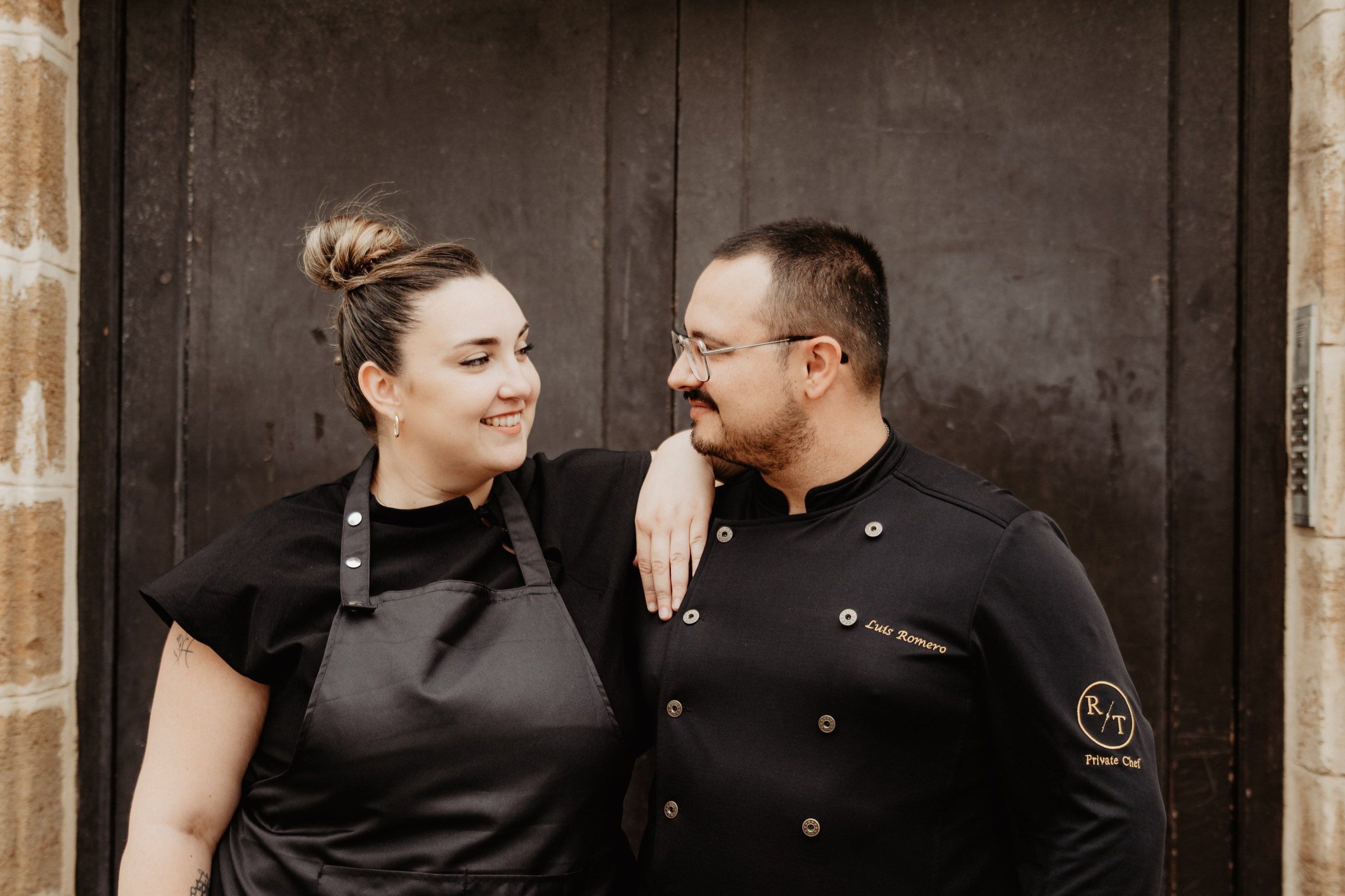 Luis and Anyi, private chefs, sharing a working moment in the kitchen