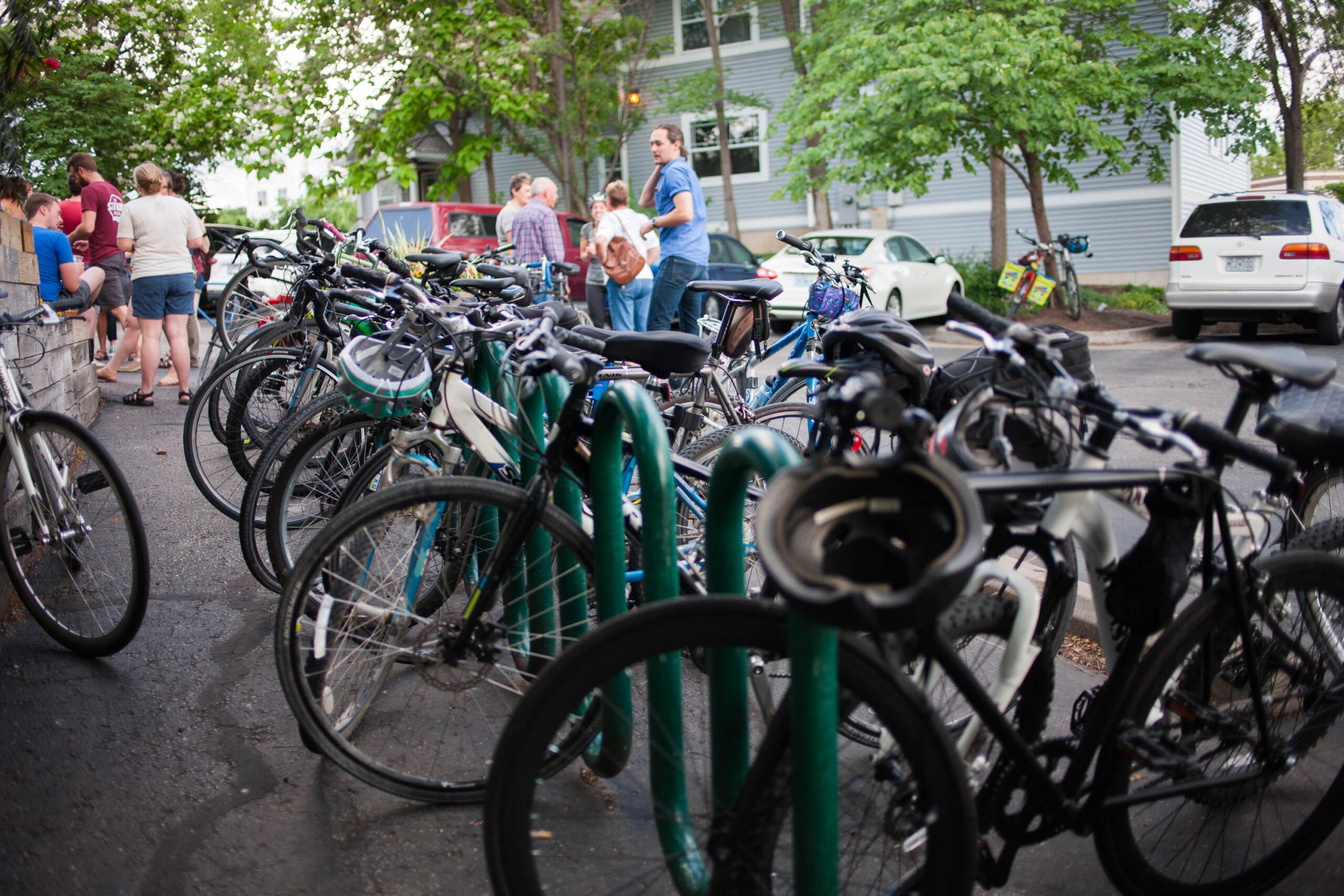 A full row of bikes on a long bike rack