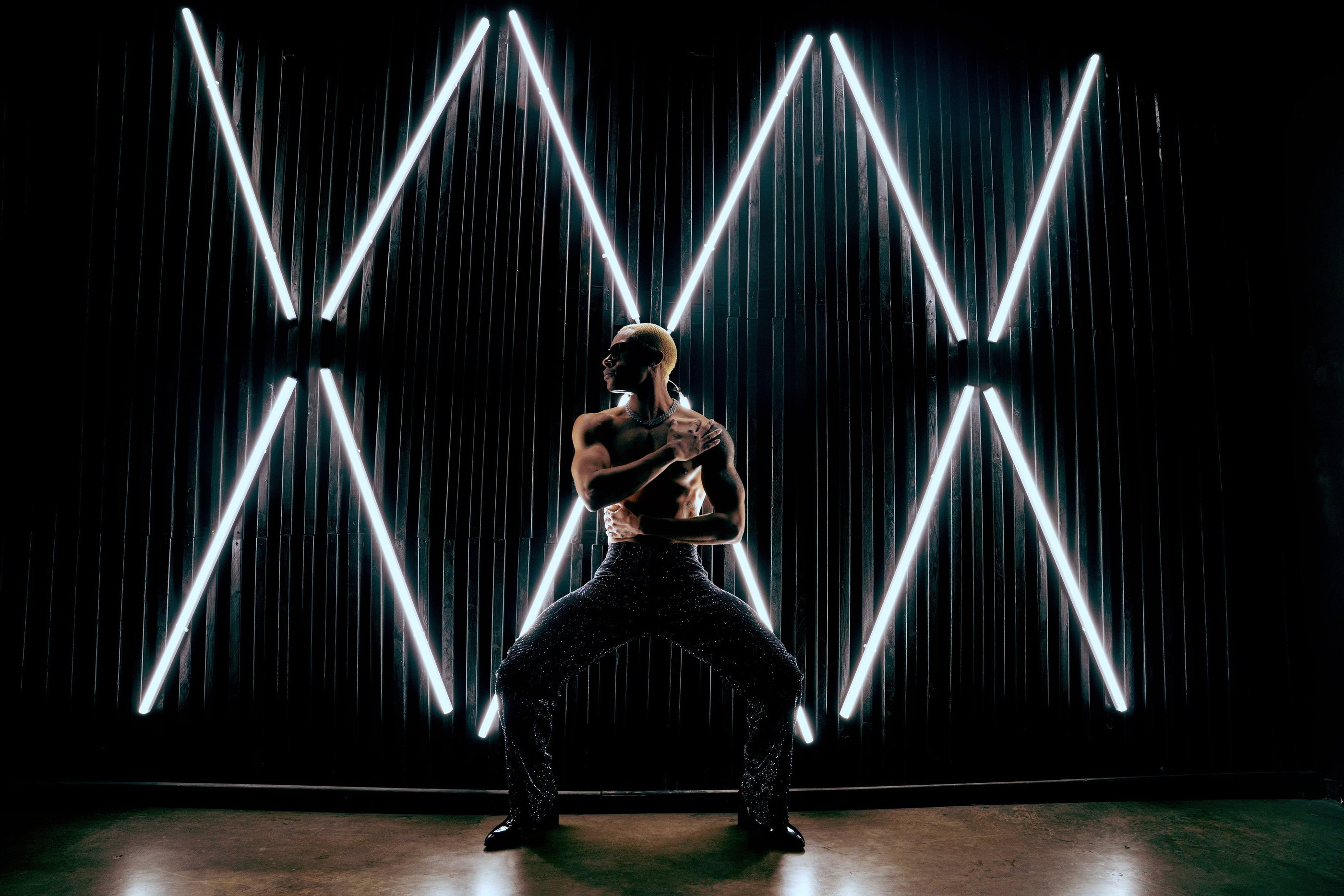 Roy Covington shirtless pressed against the wall