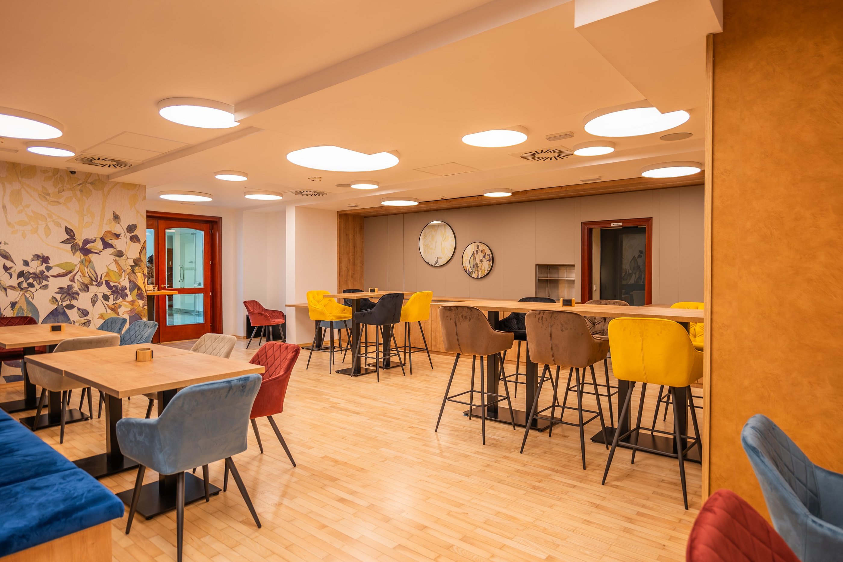 a room with a table and chairs and a clock