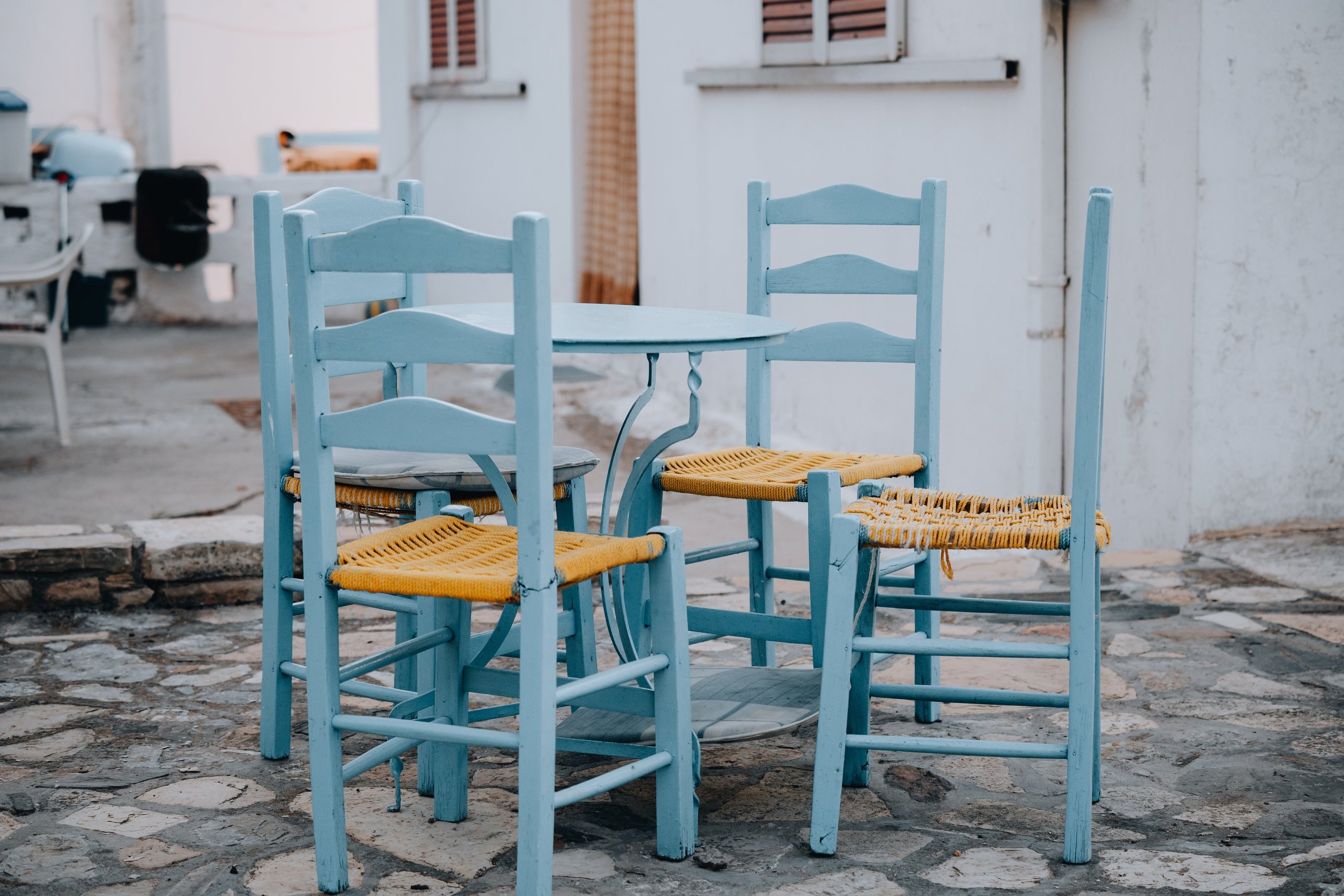 a table with chairs and chairs and a dog