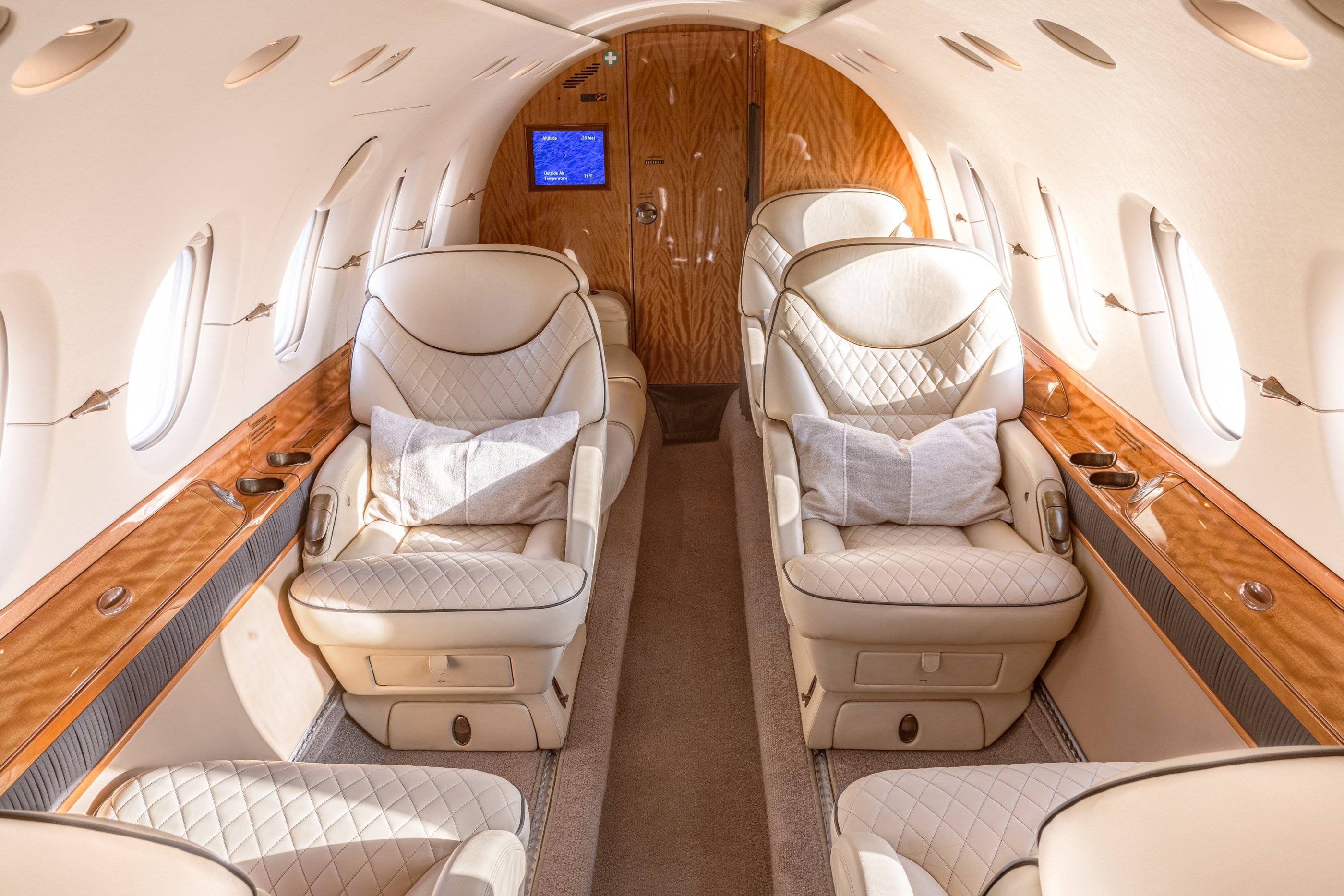 Hawker 800XP cabin interior with luxury leather seating and ambient lighting