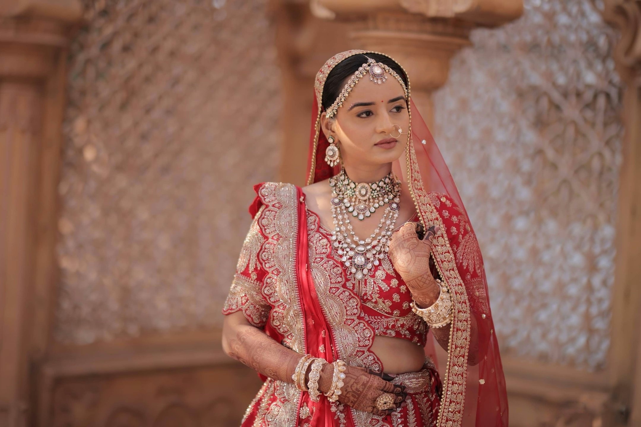 Red bridal closeup portrait with HD makeup by bridal makeup artist in Vadodara