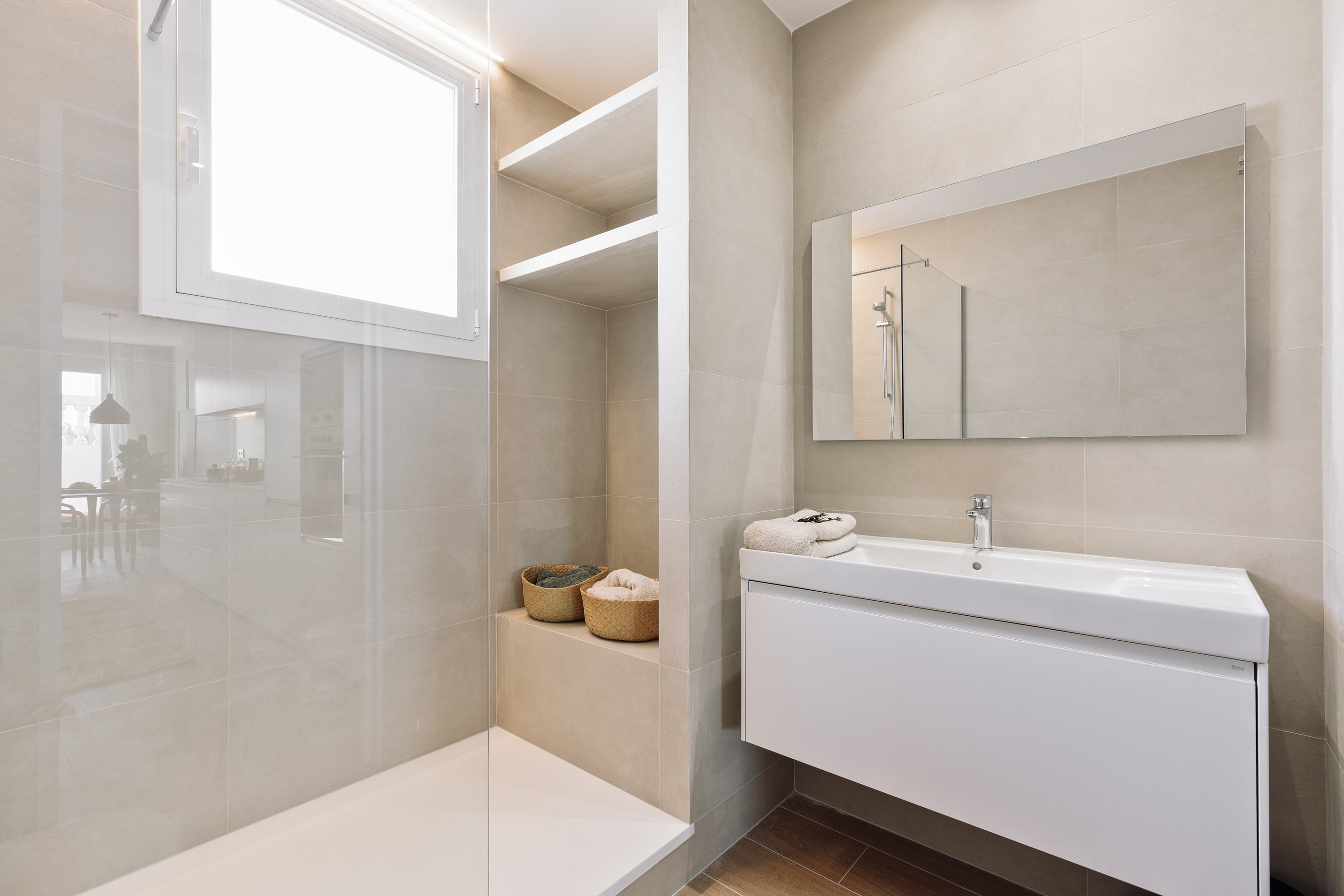 Modern bathroom design with in-built shower and natural stone tiles