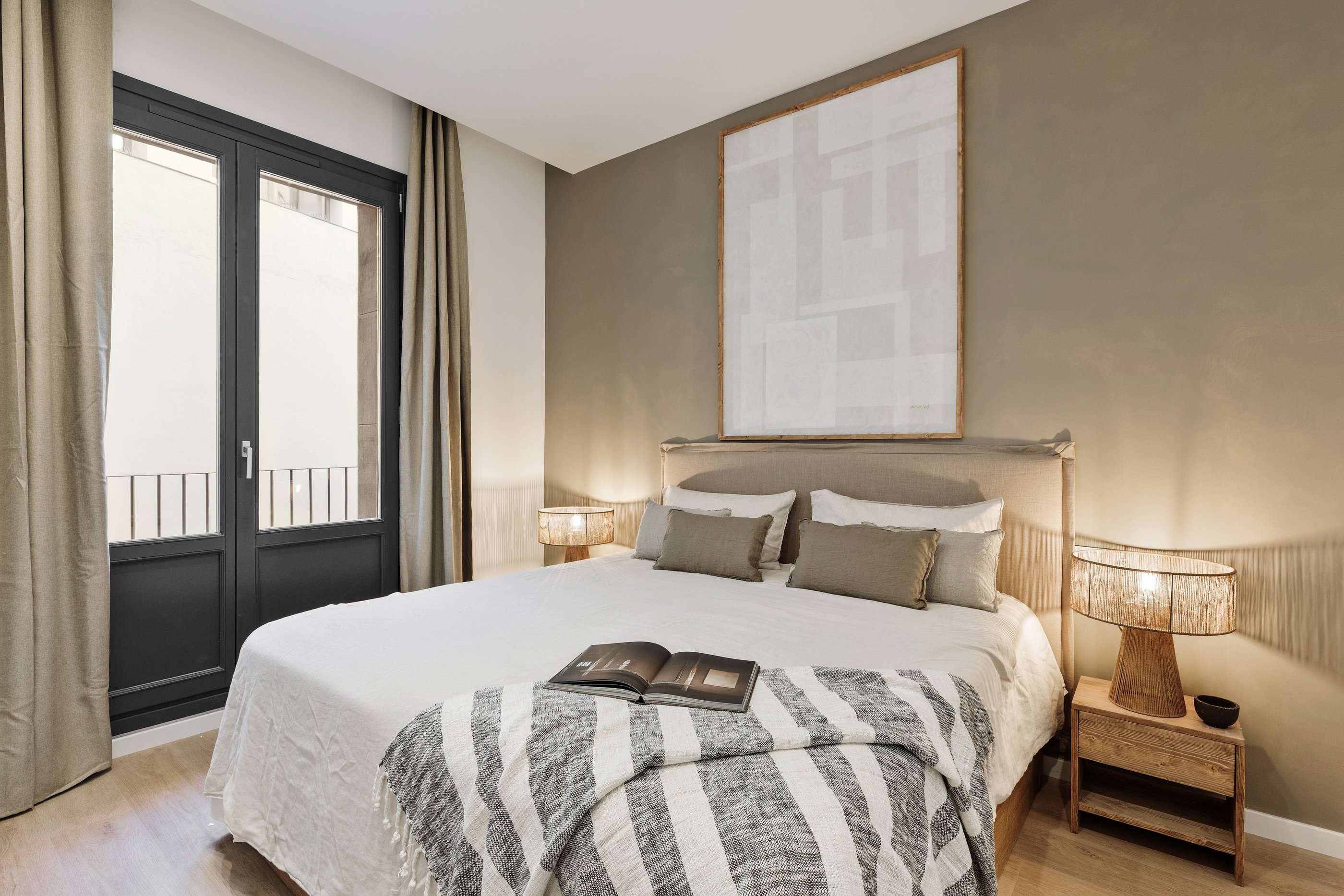 Elegant bedroom with custom artwork and brown and beige colour palette in Barcelona