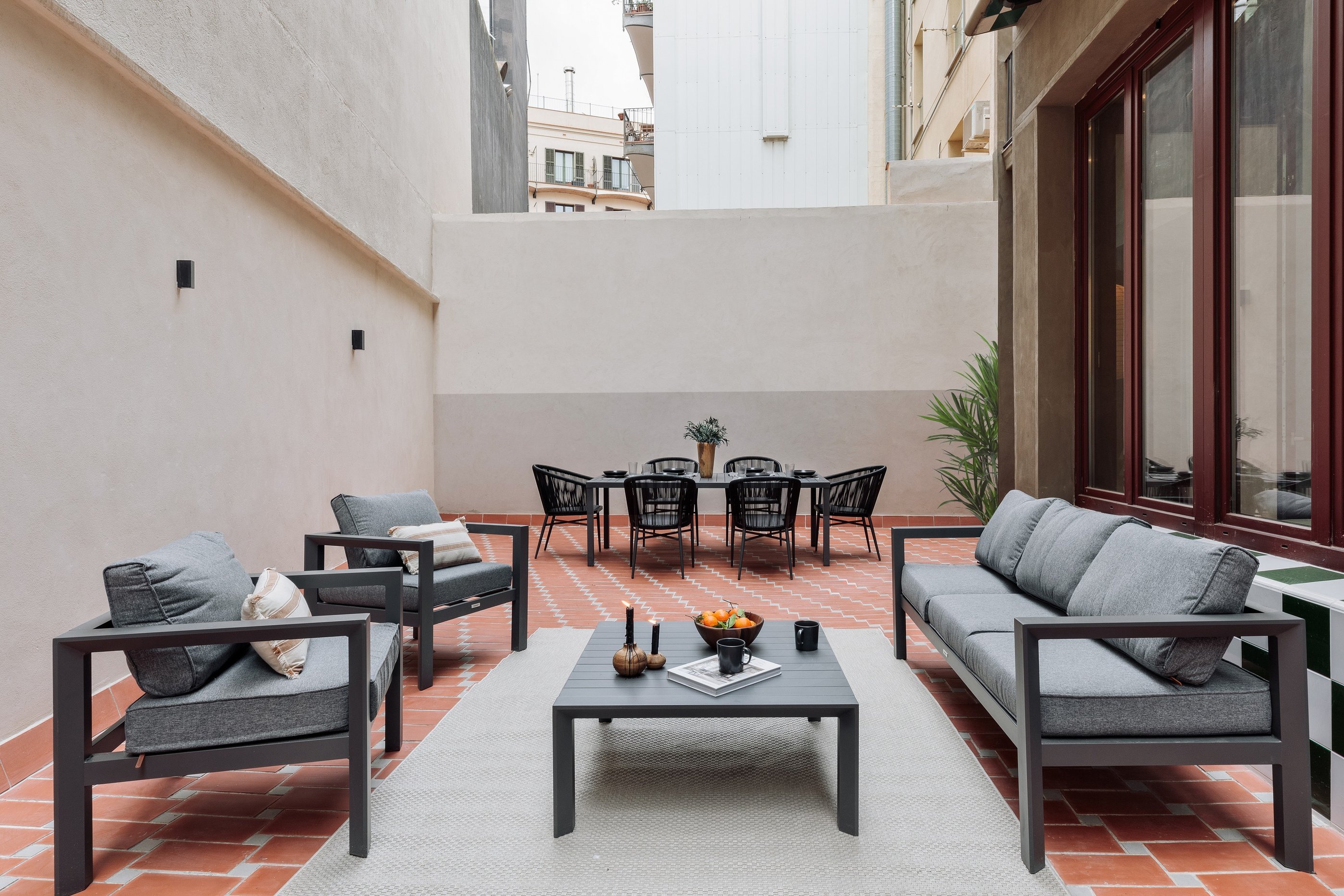 Private terrace with seating, dining area and plants, designed by SAVIA