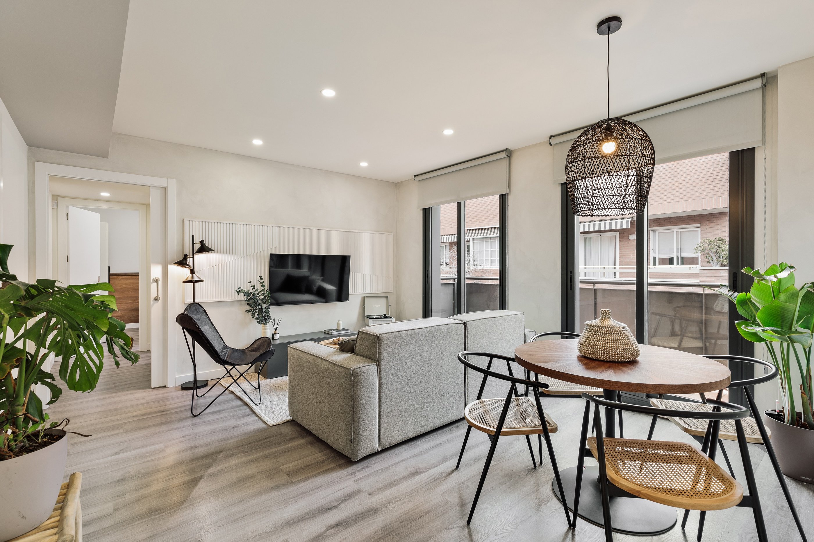 Bright living room with contemporary interior design, bespoke wall panels and black metal accents