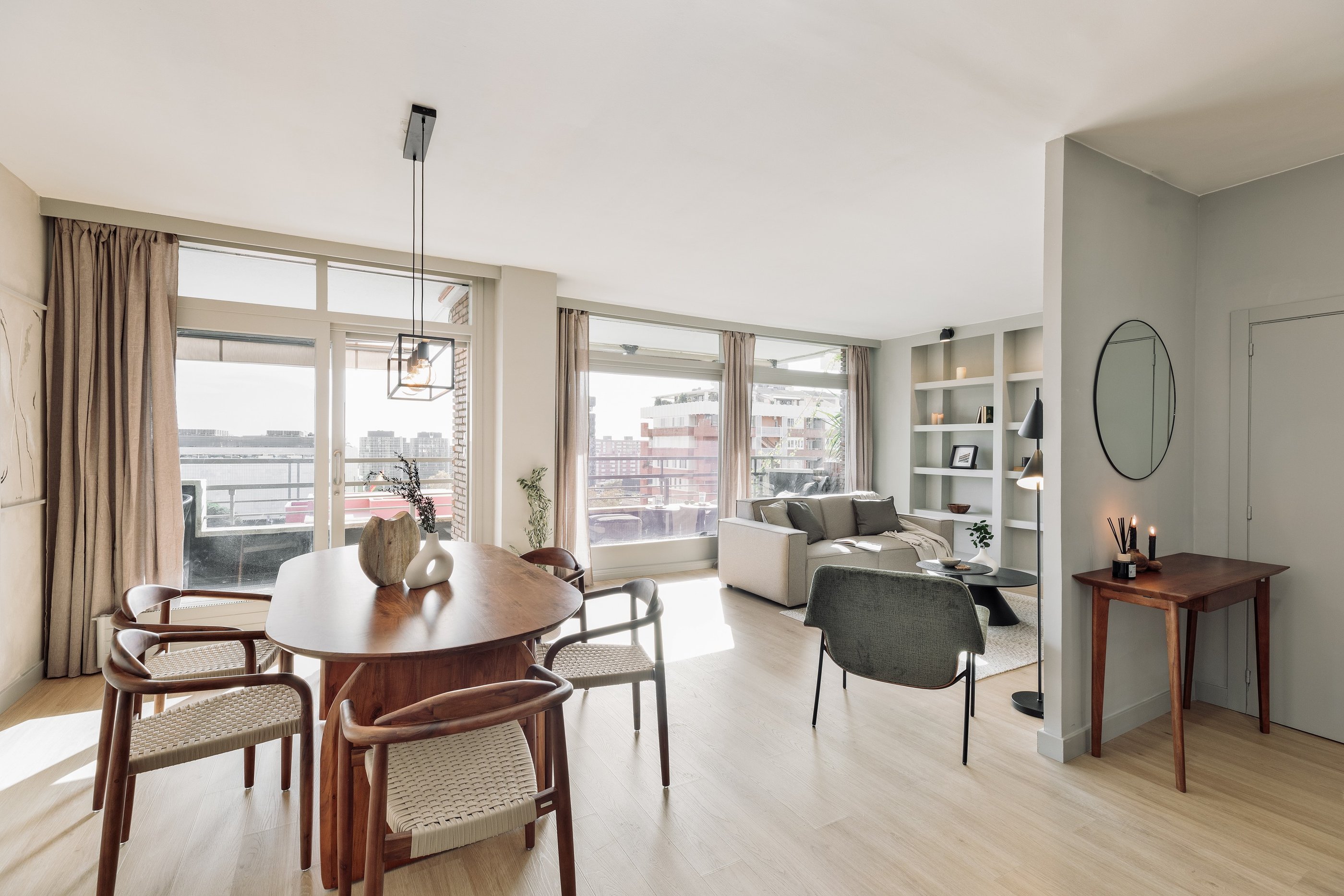 Modern dining area with metal light fixture, wooden dining table and minimalist design in Barcelona 