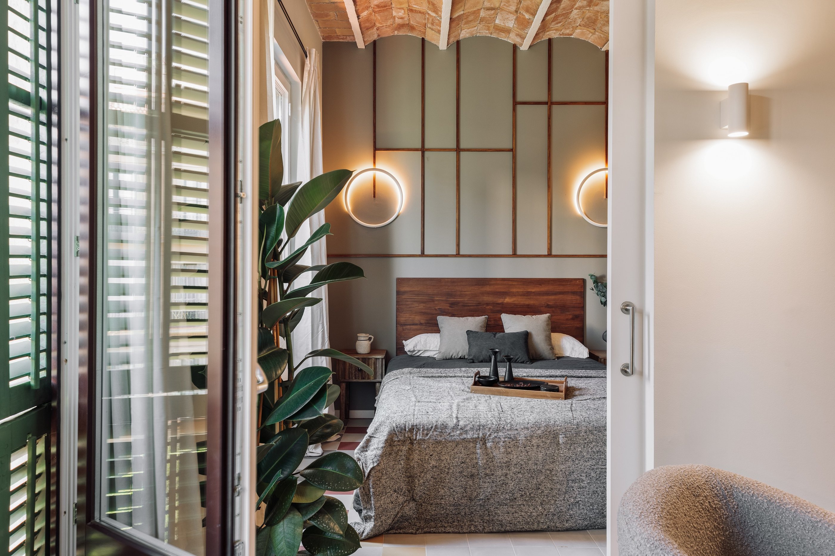 Relaxing bedroom with natural wood finishes, neutral tones, and minimalist design in Barcelona