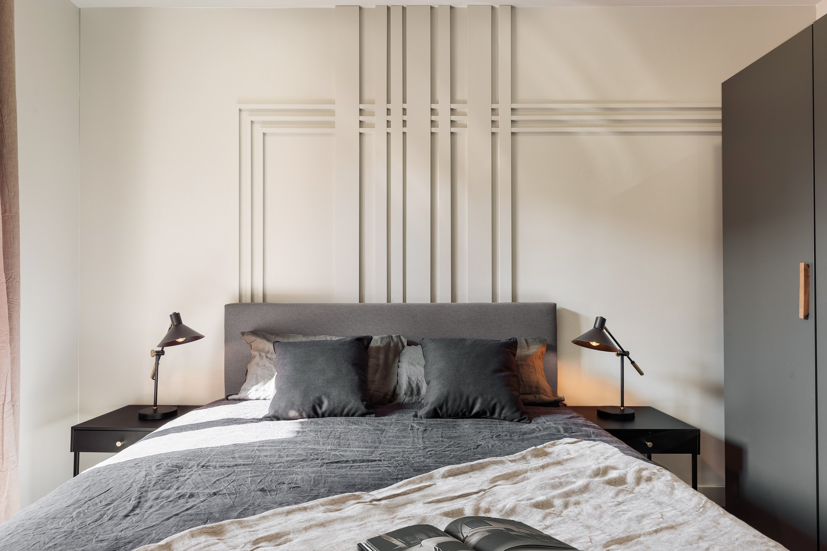 Elegant bedroom with wall panels, calm color palette and modern minimalist design in Barcelona