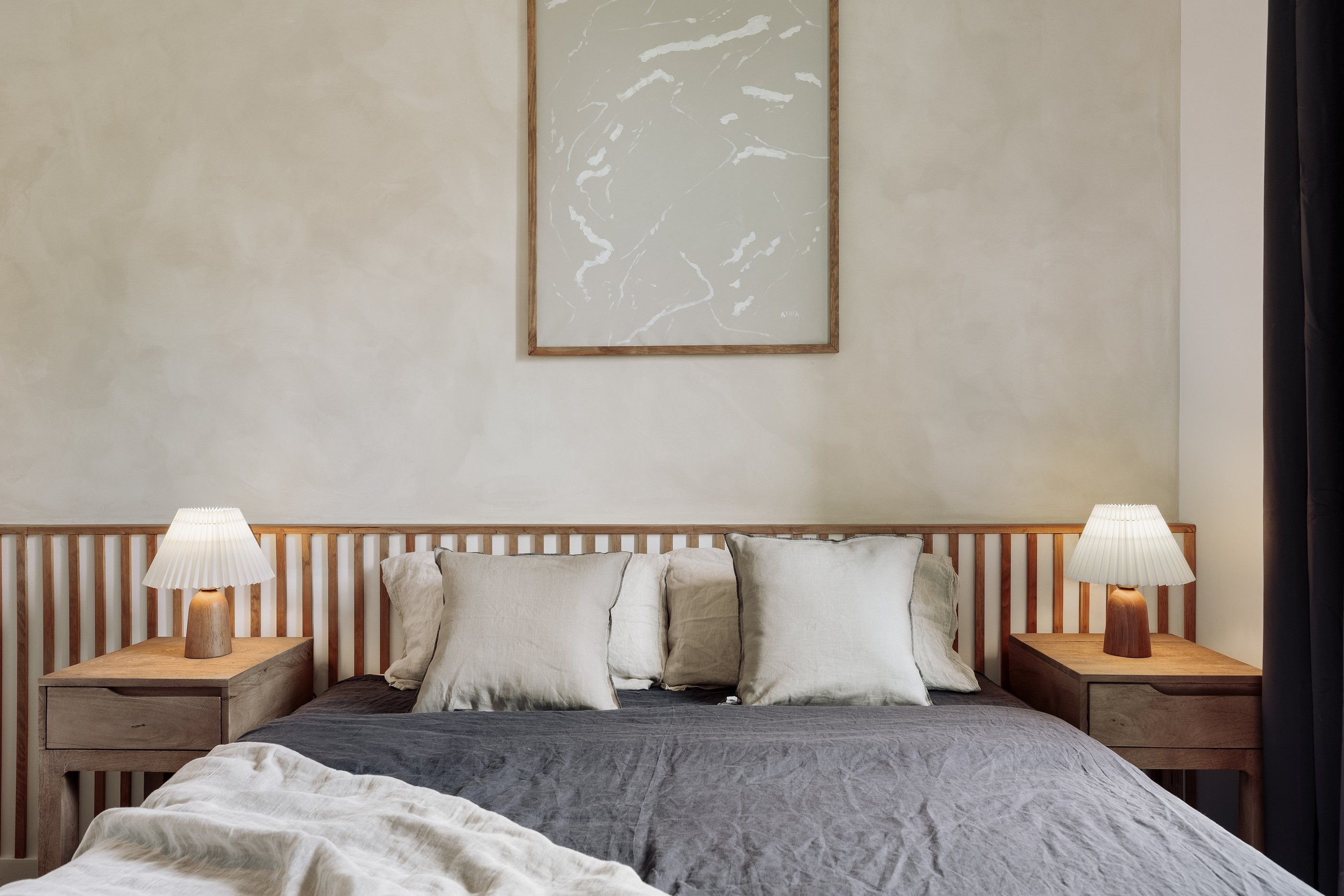 Stylish bedroom with natural textures, custom headboard, and calming color palette interior design