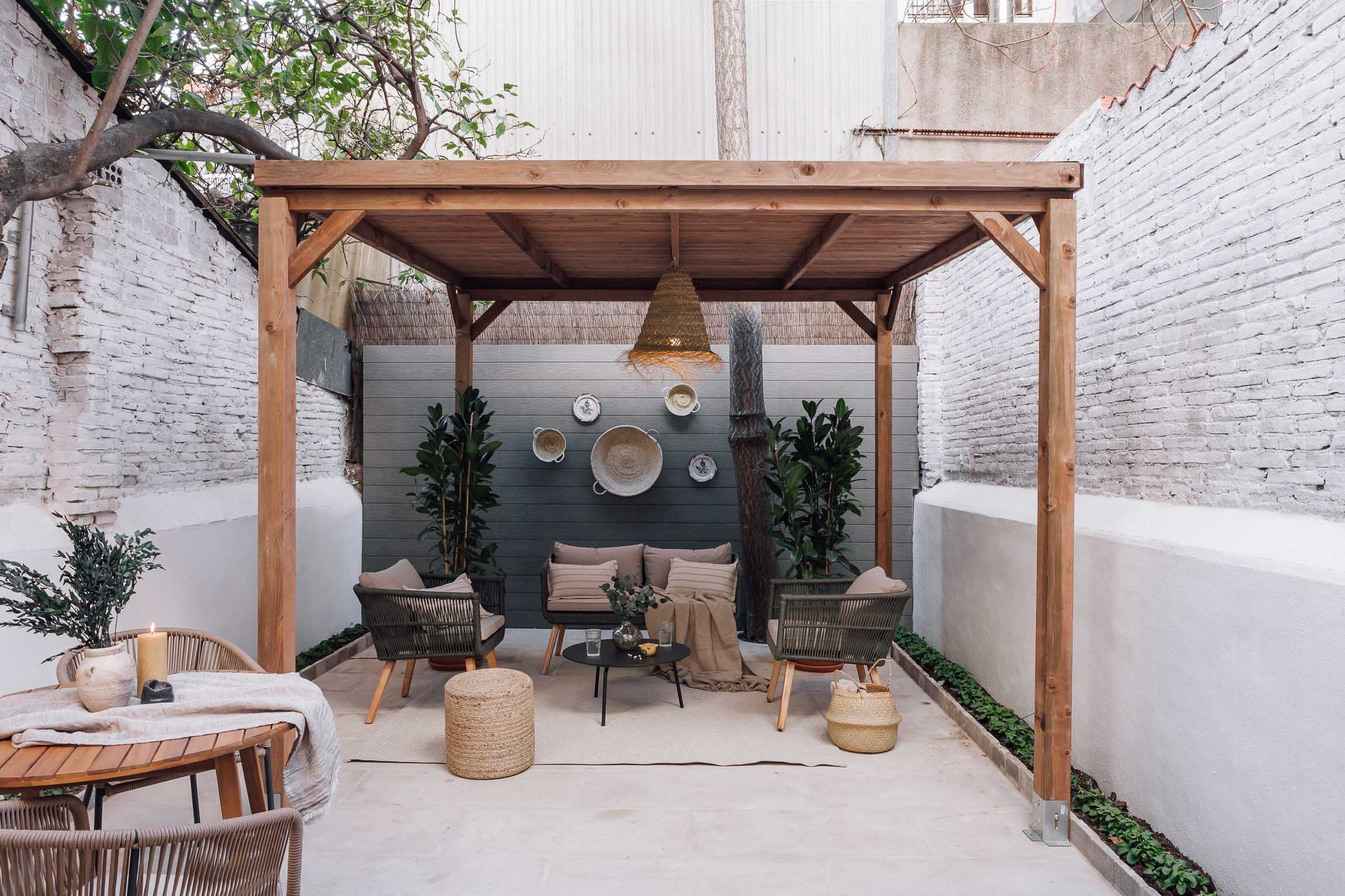 Outdoor terrace with seating and green plants, offering a serene atmosphere in Barcelona apartment