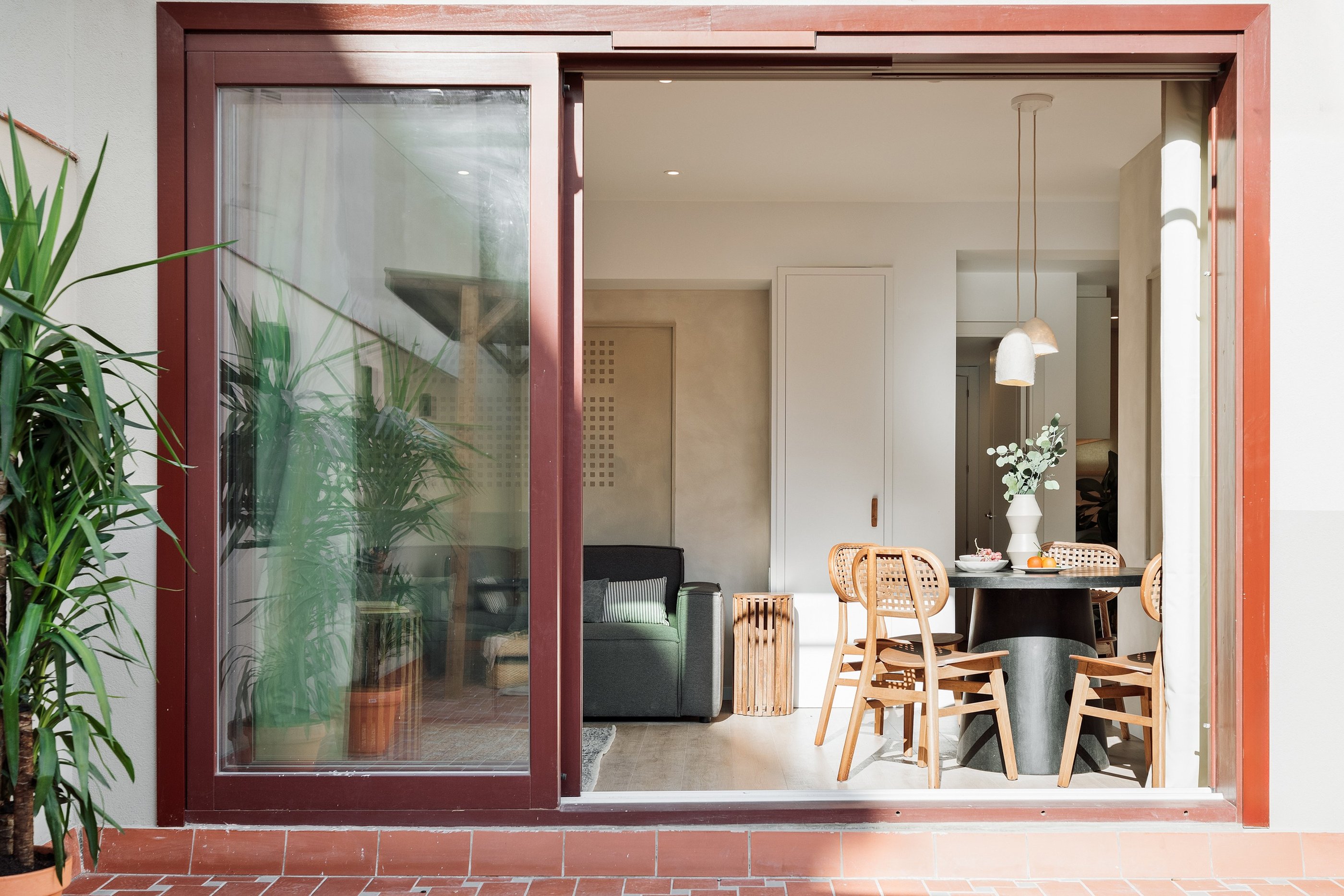 Modern dining area and terrace with sleek design elements and natural wood accents